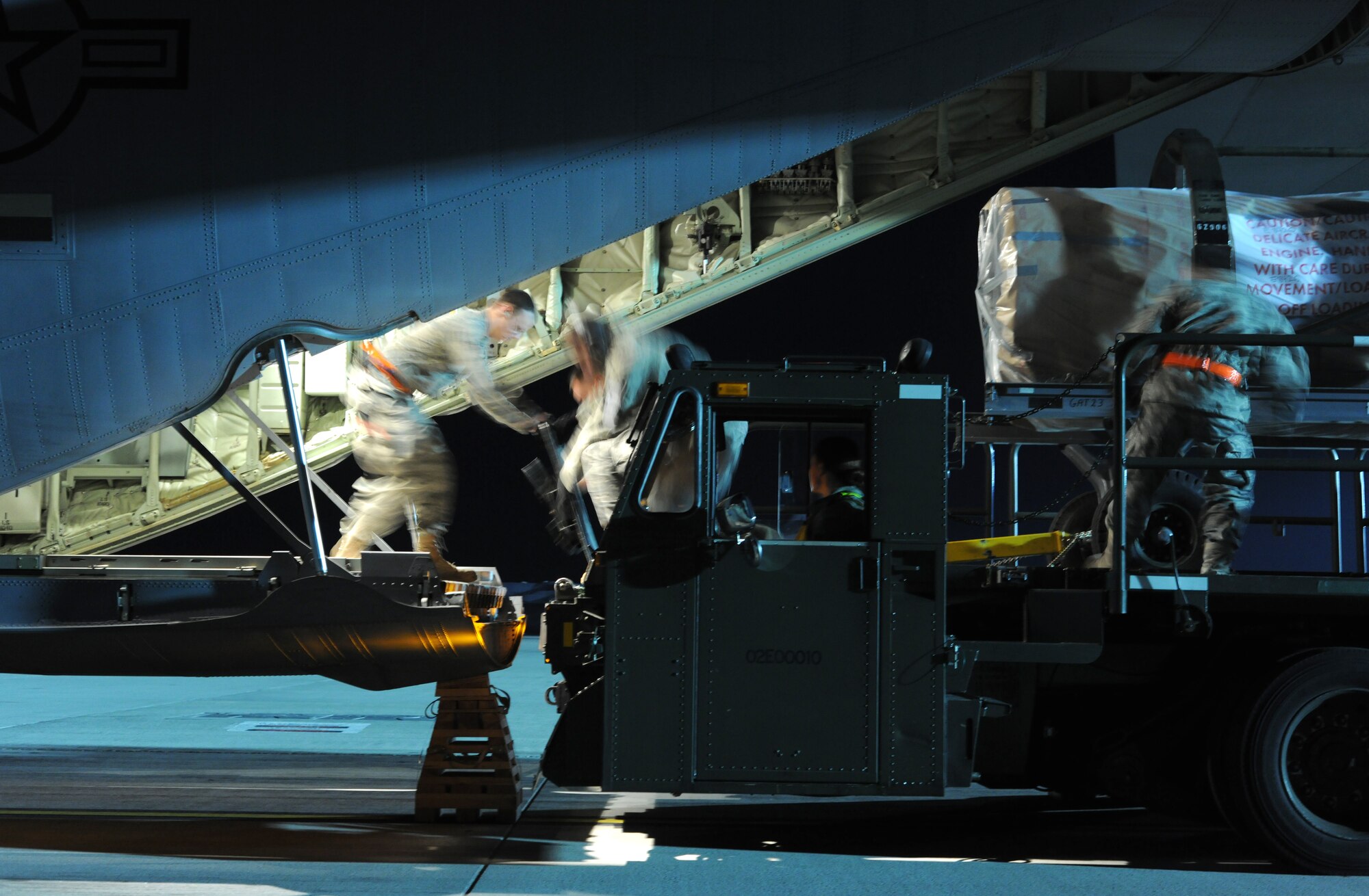 SPANGDAHLEM AIR BASE, Germany – Airmen from the 726th Air Mobility Squadron load cargo into a C-130J Super Hercules here to support Operation Odyssey Dawn March 20. Joint Task Force Odyssey Dawn is the U.S. Africa Command task force established to provide operational and tactical command and control of U.S. military forces supporting the international response to the unrest in Libya and enforcement of United Nations Security Council Resolution (UNSCR) 1973. UNSCR 1973 authorizes all necessary measures to protect civilians in Libya under threat of attack by Qadhafi regime forces.  JTF Odyssey Dawn is commanded by U.S. Navy Admiral Samuel J. Locklear, III. (U.S. Air Force photo/Senior Airman Nathanael Callon)