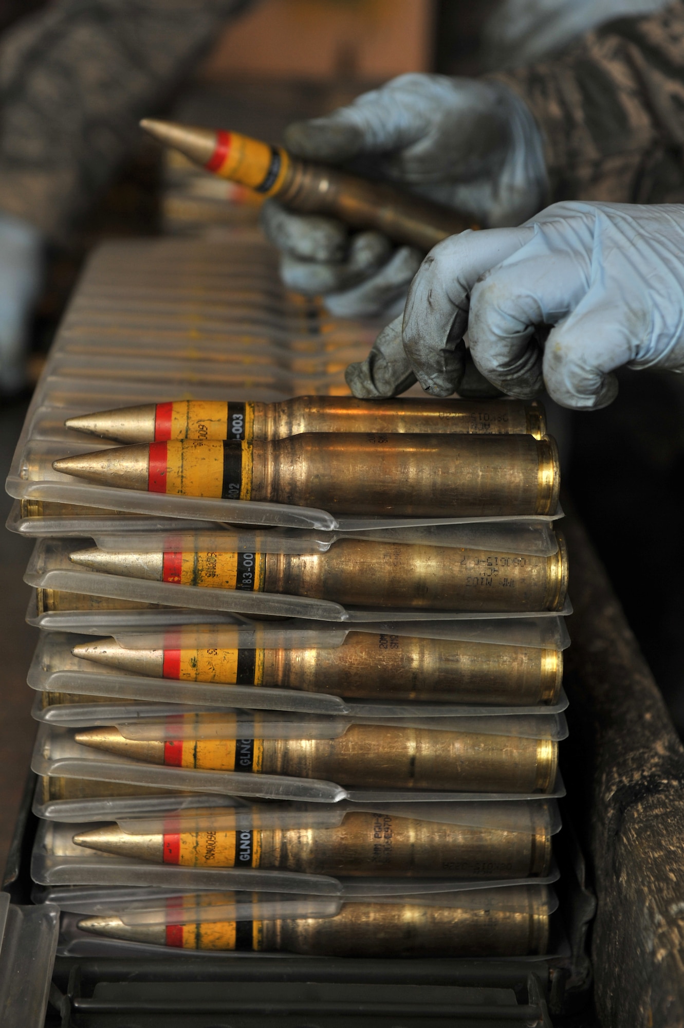 A member from the 455th Expeditionary Maintenance Squadron Ammunition Supply Point inspects 20 millimeter rounds at Bagram Airfield, Afghanistan, March 23, 2011. (U.S. Air Force photo by Senior Airman Sheila deVera)