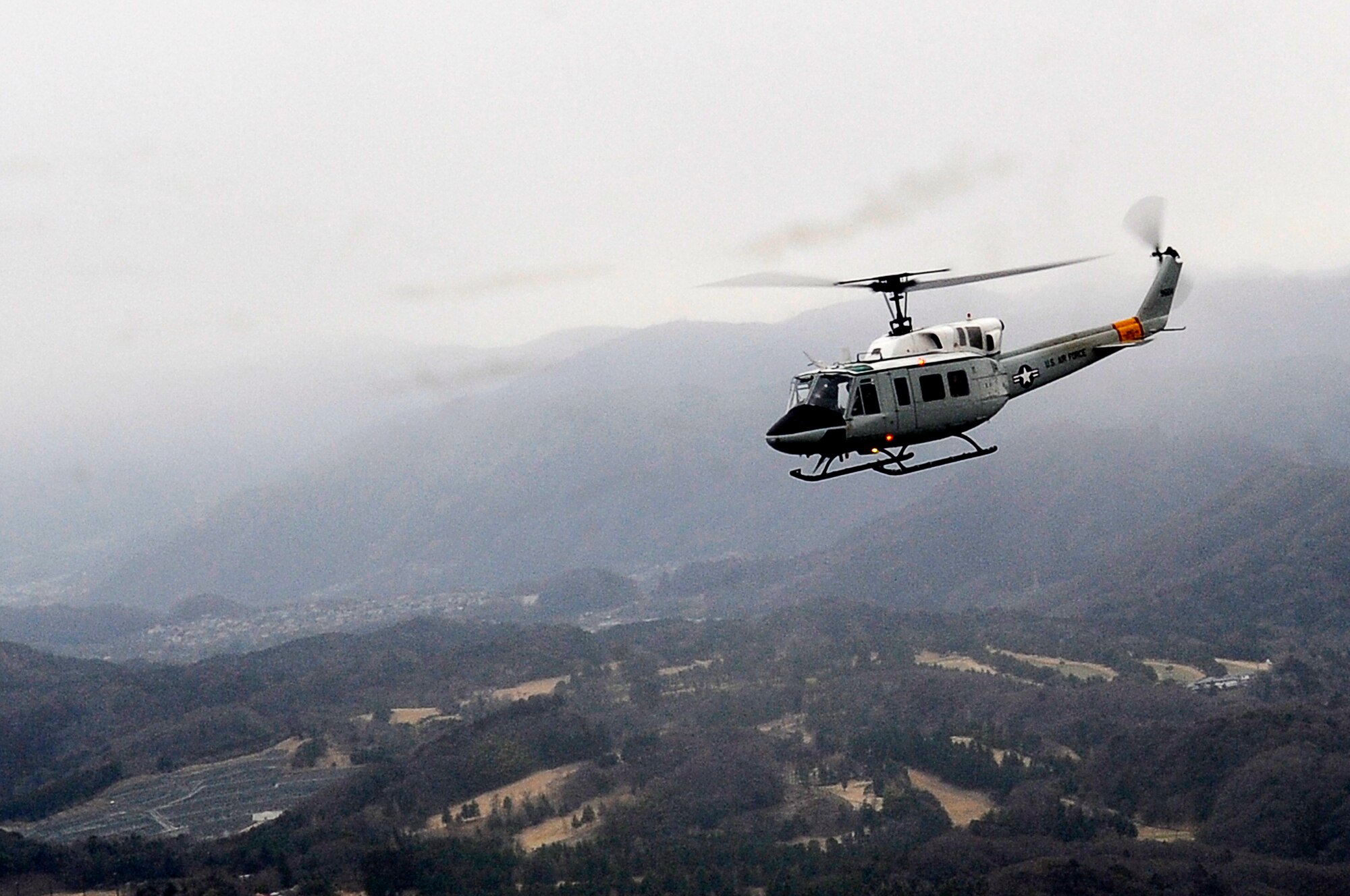 YOKOTA AIR BASE, Japan -- A UH-1 Huey helicopter flies over Japan, March 23, 2011. The helicopters are critical in providing logistical support by transporting general officers, Department of Energy personnel and other officials in support of Operation Tomodachi. (U.S. Air Force photo/Master Sgt. Jeromy K. Cross/released)






