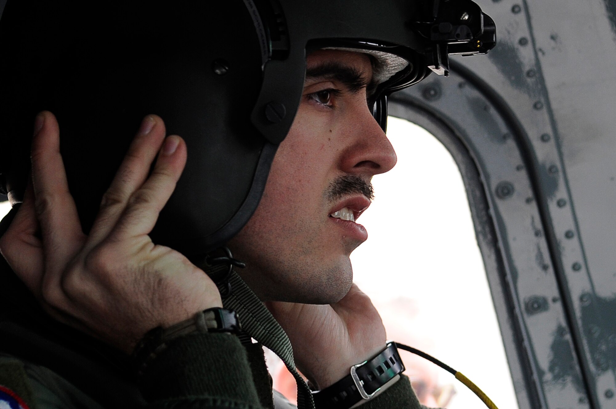 YOKOTA AIR BASE, Japan -- Senior Airman Andy Schloemer, 459th Airlift Squadron, prepares for flight in a UH-1 Huey helicopter on Yokota Air Base, March 23, 2011. The helicopters are critical in providing logistical support by transporting general officers, Department of Energy personnel and other officials in support of Operation Tomodachi. (U.S. Air Force photo/Master Sgt. Jeromy K. Cross/released)







