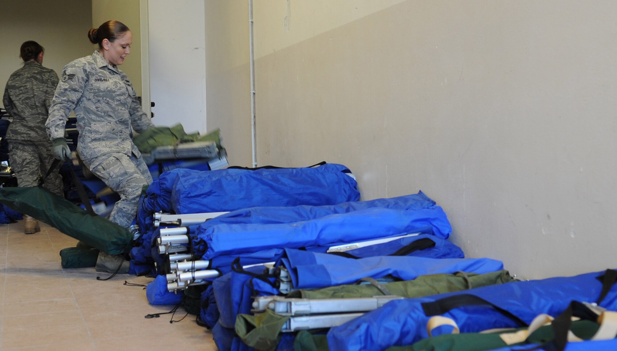 Senior Airmen Joy DiVelbiss, 31st Force Support Squadron command support section, moves cots out of a storage room for incoming personnel arriving at Aviano Air Base, Italy, in support of Operation Odyssey Dawn March 20. Joint Task Force Odyssey Dawn is the U.S. Africa Command task force established to support the larger international response to the unrest in Libya. A broad coalition of nations are partnering to enforce U.N. Security Council Resolution (UNSCR) 1973, which authorizes all necessary means to protect civilians in Libya under threat of attack by Qadhafi regime forces.  JTF Odyssey Dawn is commanded by Admiral Samuel J. Locklear, III. (U.S. Air Force photo/ Staff Sgt. Nadine Y. Barclay)