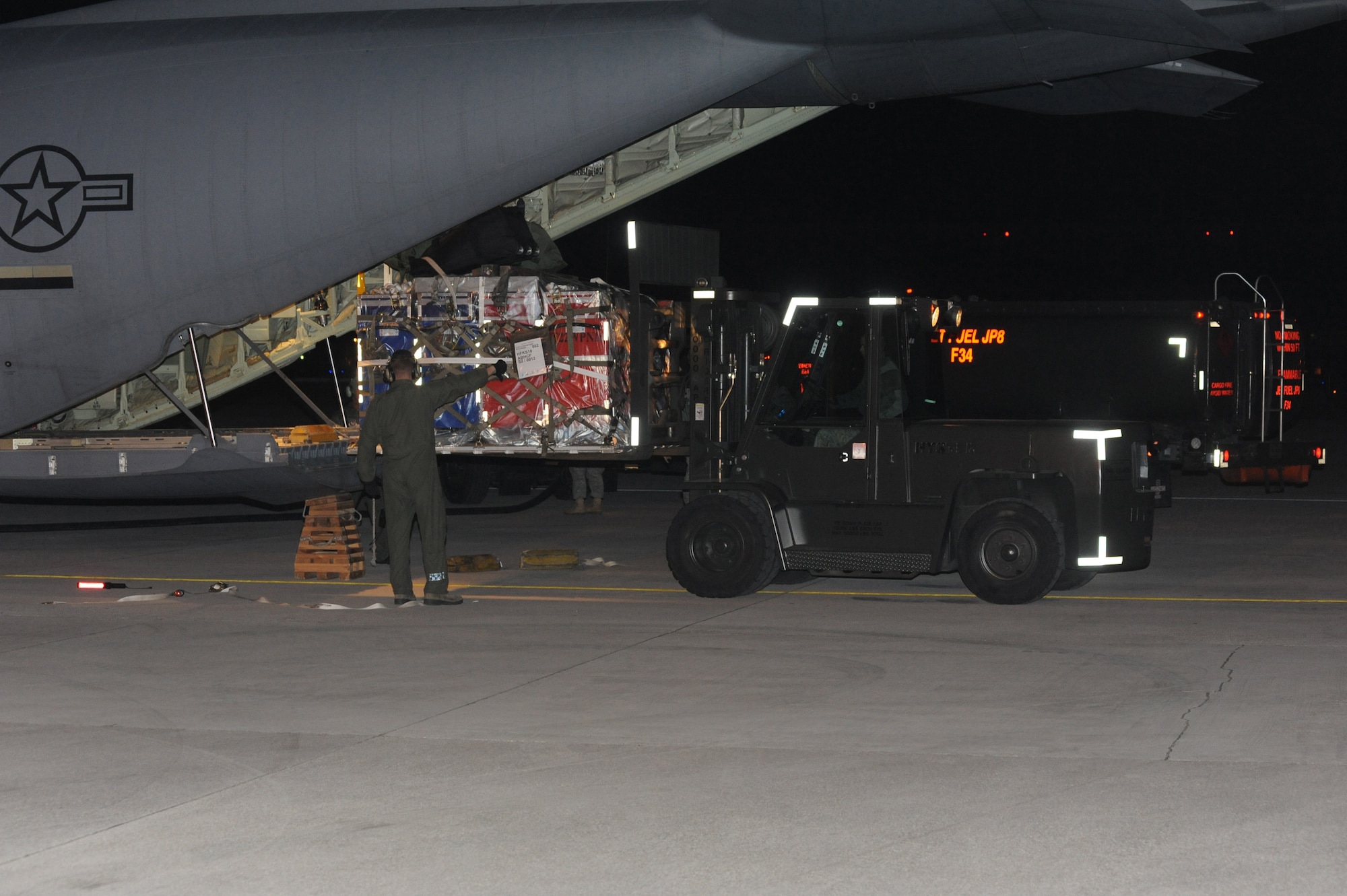 Staff Sgt. Glenn Scott, 37th Airlift Squadron C-130 Hercules loadmaster from Ramstein Air Base, Germany, directs unloading of cargo March 20 at Aviano Air Base. Joint Task Force Odyssey Dawn is the U.S. Africa Command task force established to provide operational and tactical command and control of U.S. military forces supporting the international response to the unrest in Libya and enforcement of United Nations Security Council Resolution (UNSCR) 1973. UNSCR 1973 authorizes all necessary measures to protect civilians in Libya under threat of attack by Qadhafi regime forces.  JTF Odyssey Dawn is commanded by U.S. Navy Admiral Samuel J. Locklear, III. (U.S. Air Force photo/Airman 1st Class LaVel Sterling)