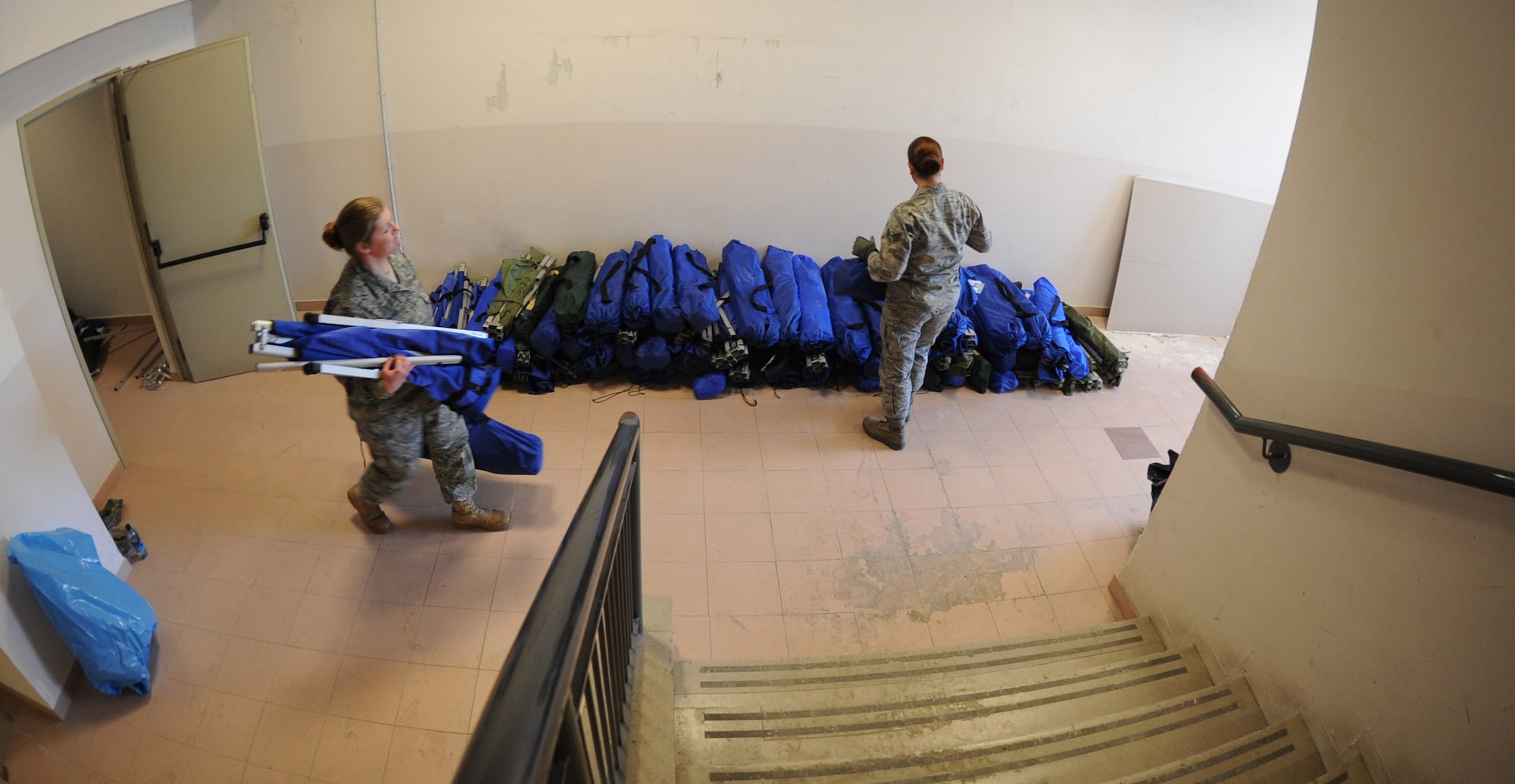 Airmen from the 31st Force Support Squadron, move cots out of a storage room for incoming personnel arriving at Aviano Air Base, Italy, in support of Operation Odyssey Dawn March 20. Joint Task Force Odyssey Dawn is the U.S. Africa Command task force established to support the larger international response to the unrest in Libya.  A broad coalition of nations are partnering to enforce U.N. Security Council Resolution (UNSCR) 1973, which authorizes all necessary means to protect civilians in Libya under threat of attack by Qadhafi regime forces.  JTF Odyssey Dawn is commanded by Admiral Samuel J. Locklear, III. (U.S. Air Force photo/Staff Sgt. Nadine Y. Barclay)