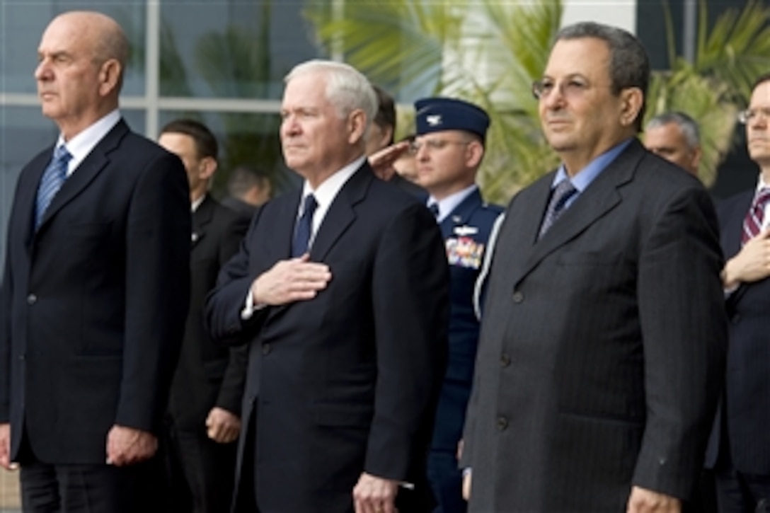 Secretary of Defense Robert M. Gates and Israeli Defense Minister Ehud Barak (right) and their staff members render honors during the playing of the national anthem during an honor arrival ceremony in Tel Aviv, Israel, on March 24, 2011.  