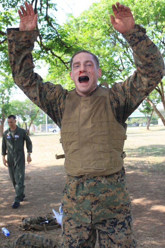 Lance Cpl. Anthony J. Olivieri, Marine All-Weather Fighter Attack Squadron 533 airframes mechanic, comes into the upward position while performing a “burpee” during the Marine Corps Martial Arts Program brown belt course station rotation drill here March 25.