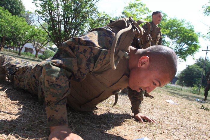Lance Cpl. Anthony J. Olivieri, Marine All-Weather Fighter Attack Squadron 533 airframes mechanic, comes into the upward position while performing a “burpee” during the Marine Corps Martial Arts Program brown belt course station rotation drill here March 25.