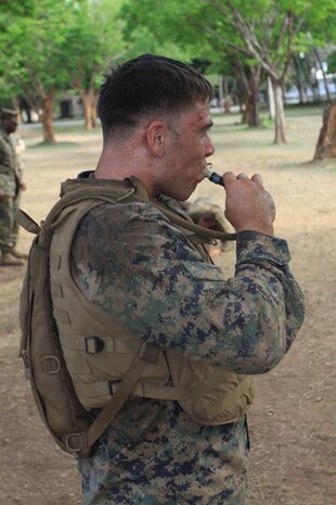 Sgt. Shawanda Woods, Marine All-Weather Fighter Attack Squadron 533 S-1 chief, grapples with Marine Corps Martial Arts Program instructor Chief Warrant Officer 2 Kevin Wernsing, VMFA(AW)-533 ordnance officer, during the MCMAP brown belt course station rotation drill here March 25.