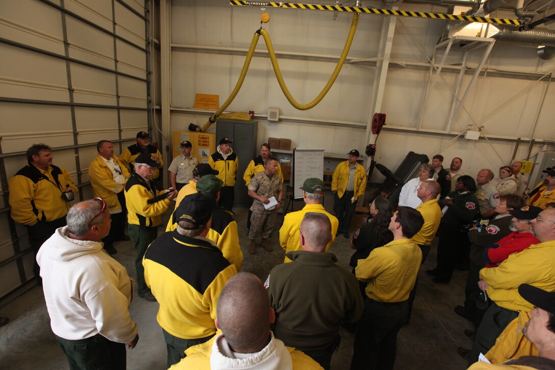 MARINE CORPS BASE CAMP LEJEUNE N.C. – Col. Daniel Lecce, commanding officer for Marine Corps Base Camp Lejeune, talks to firefighters and emergency personnel who were fighting the SR-8 fire, March 25.