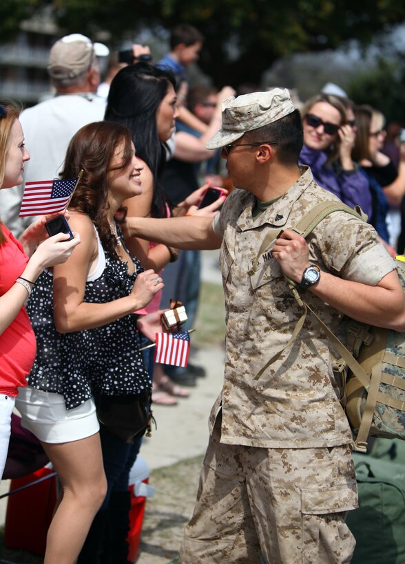 A Marine with Weapons Company, 1st Battalion, 8th Marine Regiment, 2nd Marine Division, embraces his wife aboard Marine Corps Base Camp Lejeune, N.C., during a welcome home ceremony March 25, 2011. The unit is returning after a seven-month deployment to Helmand Province, Afghanistan, in support of Operation Enduring Freedom.