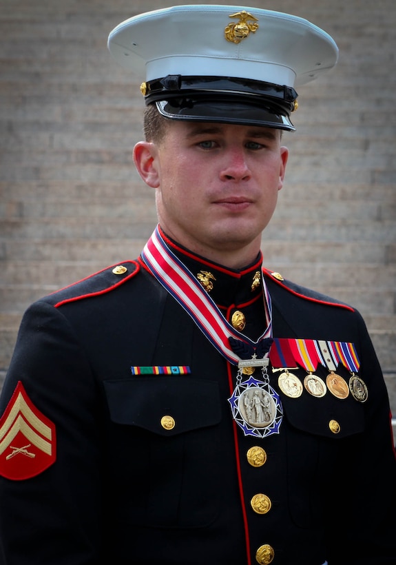 Corporal Christopher Conley, a crew chief with 2nd Assault Amphibian Battalion, 2nd Marine Division, poses with the Citizen Service Before Self Honors Medal during a ceremony at Arlington National Cemetery March 25, 2011. Conley received the award on behalf of his mother, Marie Conley of Boston, who was recognized for sacrificing her own life to save a young boy by shielding him with her own body from a car that was barreling towards him October 21, 2008.