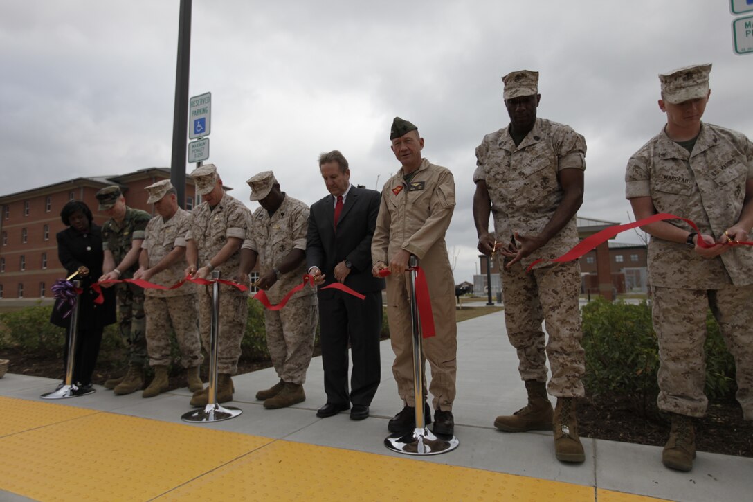 2nd Marine Aircraft Wing Commanding General Maj. Gen. Jon M. Davis, third from right, leads an official ribbon-cutting ceremony held aboard Marine Corps Air Station Cherry Point March 25 for the unveiling of two new bachelor enlisted quarters adjacent to the station mess hall. The new quarters will house more than 300 single Marines and Sailors aboard the air station.