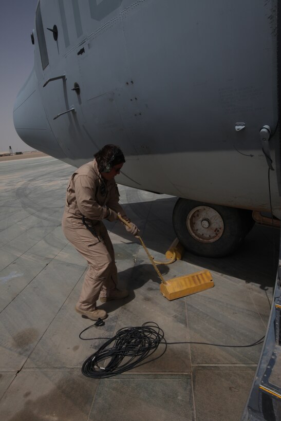 Cpl. Jessica M. Egan, a crew chief with Marine Aerial Refueler Transport Squadron 352, performs a preflight inspection on the Harvest Hawk equipped KC-130J at Camp Dwyer, Afghanistan, March 25. The one-of-a-kind Harvest Hawk system includes a version of the target sight sensor used on the AH-1Z Cobra attack helicopter as well as a complement  of four AGM-114 Hellfire and 10 Griffin missiles.