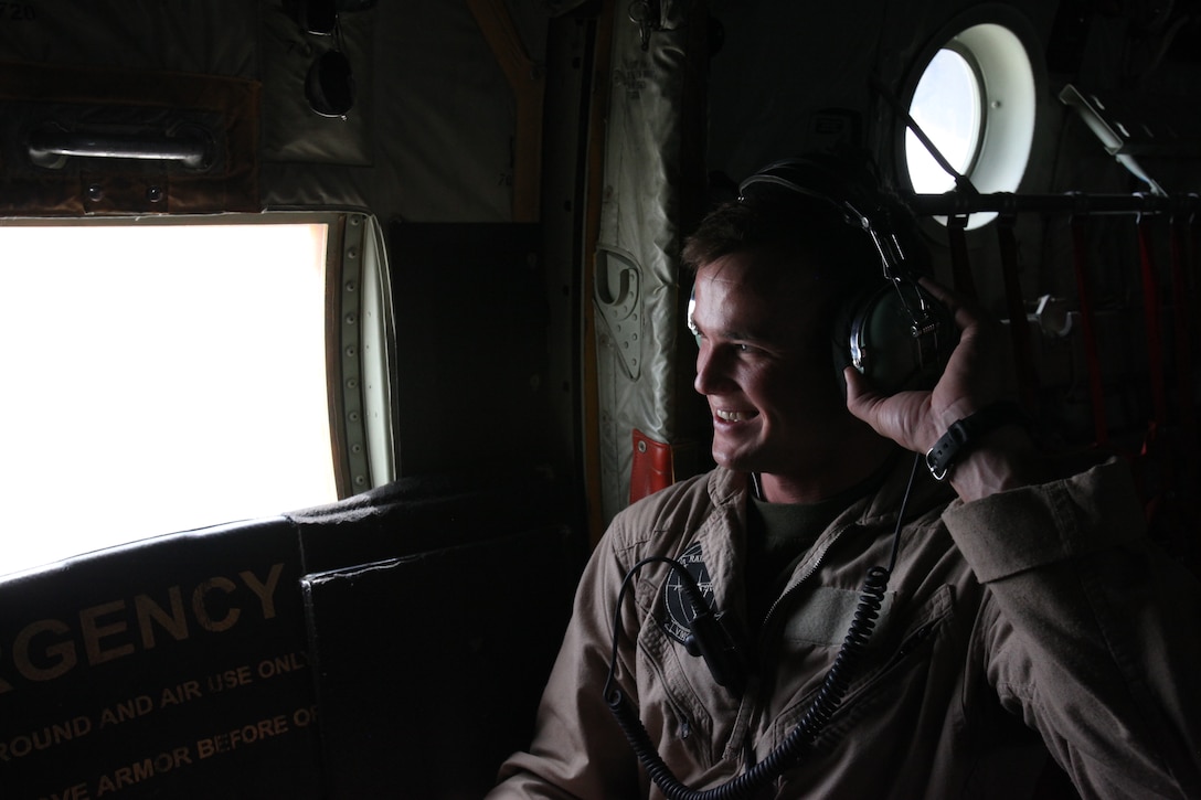 Lance Cpl. Michael A. Preuss, a loadmaster with Marine Aerial Refueler Transport Squadron 352, prepares to take off aboard the Harvest Hawk eqipped KC-130J from Camp Dwyer, Afghanistan, March 25. The one-of-a-kind Harvest Hawk system includes a version of the target sight sensor used on the AH-1Z Cobra attack helicopter as well as a complement of four AGM-114 Hellfire and 10 Griffin missiles. This unique variant of the KC-130J supports 2nd Marine Aircraft Wing (Forward) in providing closer air support and surveillance for coalition troops on the ground in southwestern Afghanistan.