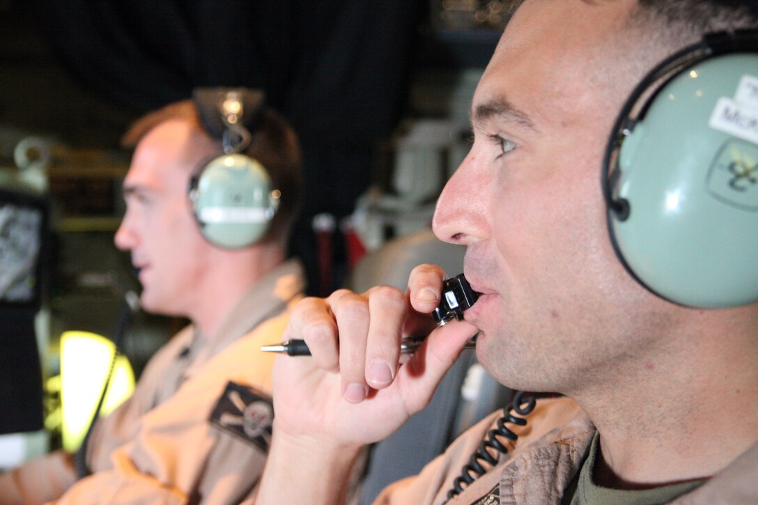 Capt. John L. Belsha, left, and Capt. Jason R. McKown, fire control officers with Marine Aerial Refueler Transport Squadron 352, fly the southwestern Afghanistan skies aboard the HarvestHawk equipped KC-130J, March 25. The one-of-a-kind Harvest Hawk system includes a version of the target sight sensor used on the AH-1Z Cobra attack helicopter as well as a complement of four AGM-114 Hellfire and 10 Griffin missiles. This unique variant of the KC-130J supports 2nd Marine Aircraft Wing (Forward) in providing closer air support and surveillance for coalition troops on the ground in southwestern Afghanistan.