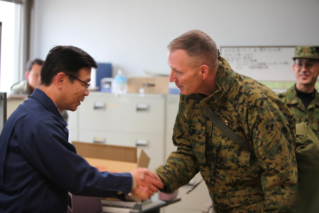 Maj. Gen. Mark A. Brilakis, the commanding general for 3rd Marine Division and Joint Forces Land Component commander for Operation Tomodachi, greets a senior airport official at the Sendai Airport here March 25. 3rd MarDiv was able to rapidly deploy personnel, supplies and equipment in order to establish the JFLCC following the 9.0 magnitude earthquake and subsequent tsunami that struck northern Japan March 11.