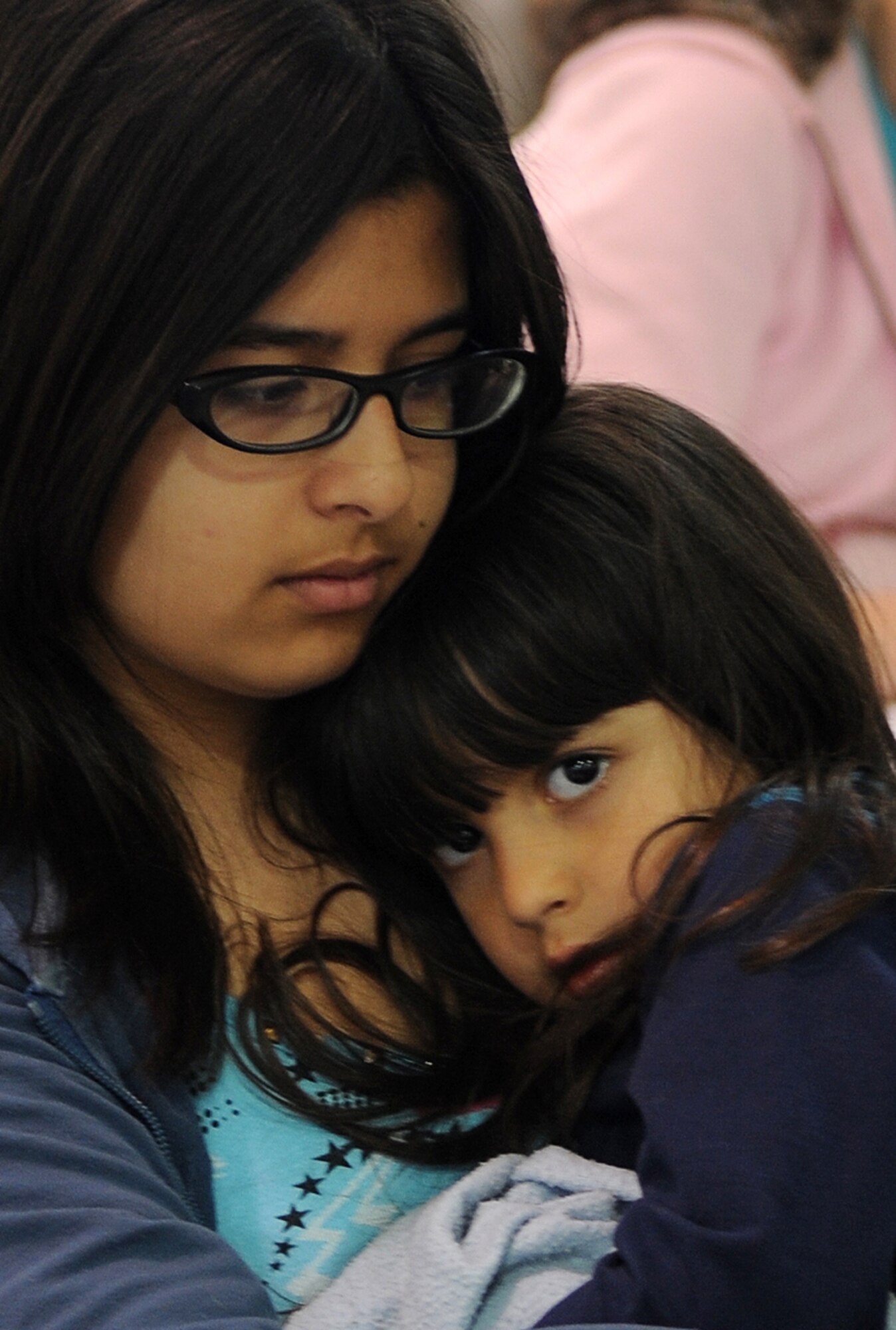 Buckley Air Force Base, Colo- Peanna Wade and her daughter, Reilli, take a moment to rest after arriving to Denver International Airport March 25, 2011. Operation Pacific Passage has been able to bring home evacuees of military dependents stationed in Japan. (U.S. Air Force photo by Airman 1st Class Marcy Glass)