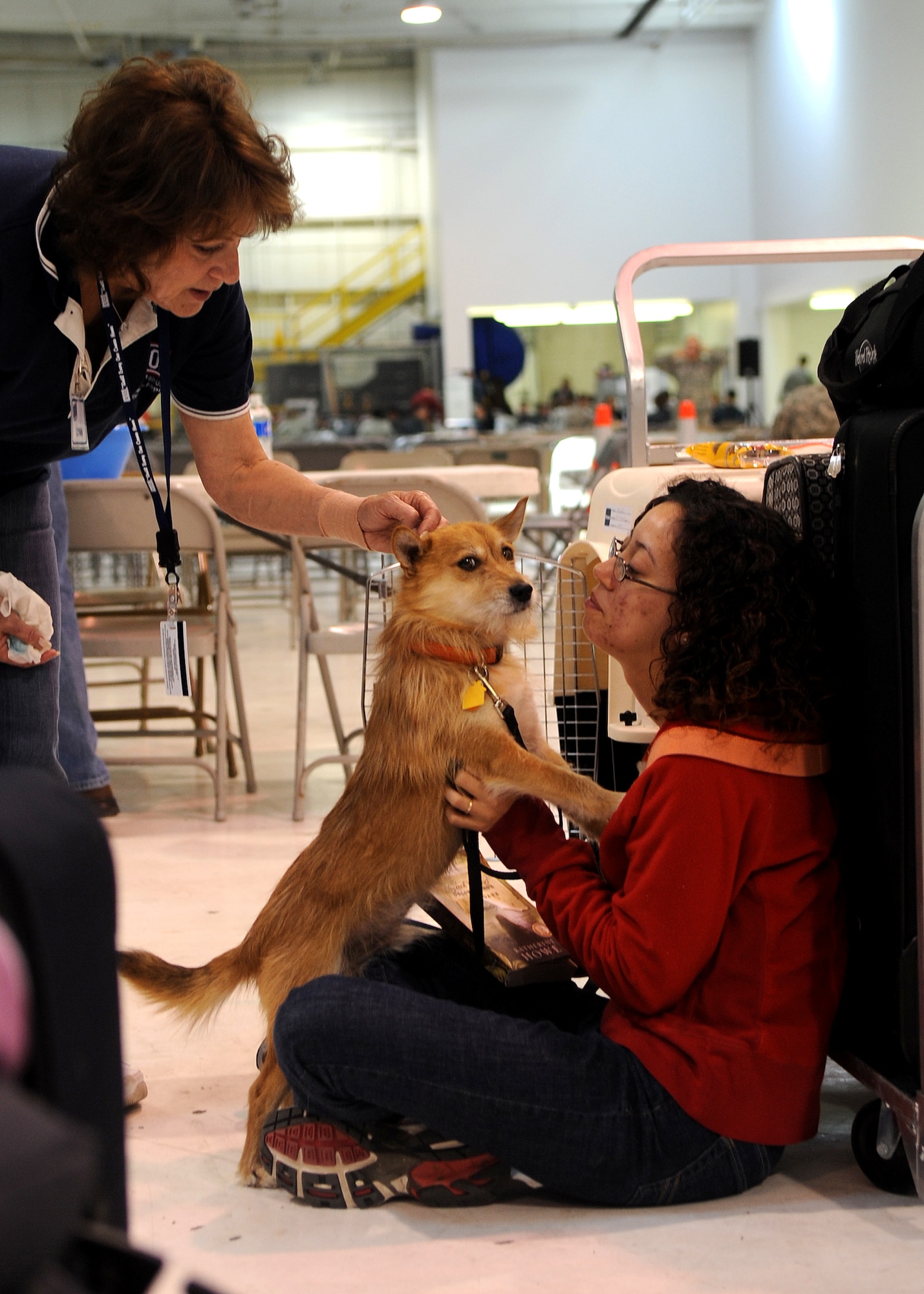 Buckley Air Force Base, Colo- Jacquelyn Cowgill and her K9 companion, Todd, arrive at Denver International Airport from Misawa Air Force Base March 25, 2011. Operation Pacific Passage has allowed military dependent evacuee's and their pets to come home to the United States after the devastating earthquake and tsunami struck Japan March 11, 2011.  (U.S. Air Force photo by Airman 1st Class Marcy Glass)