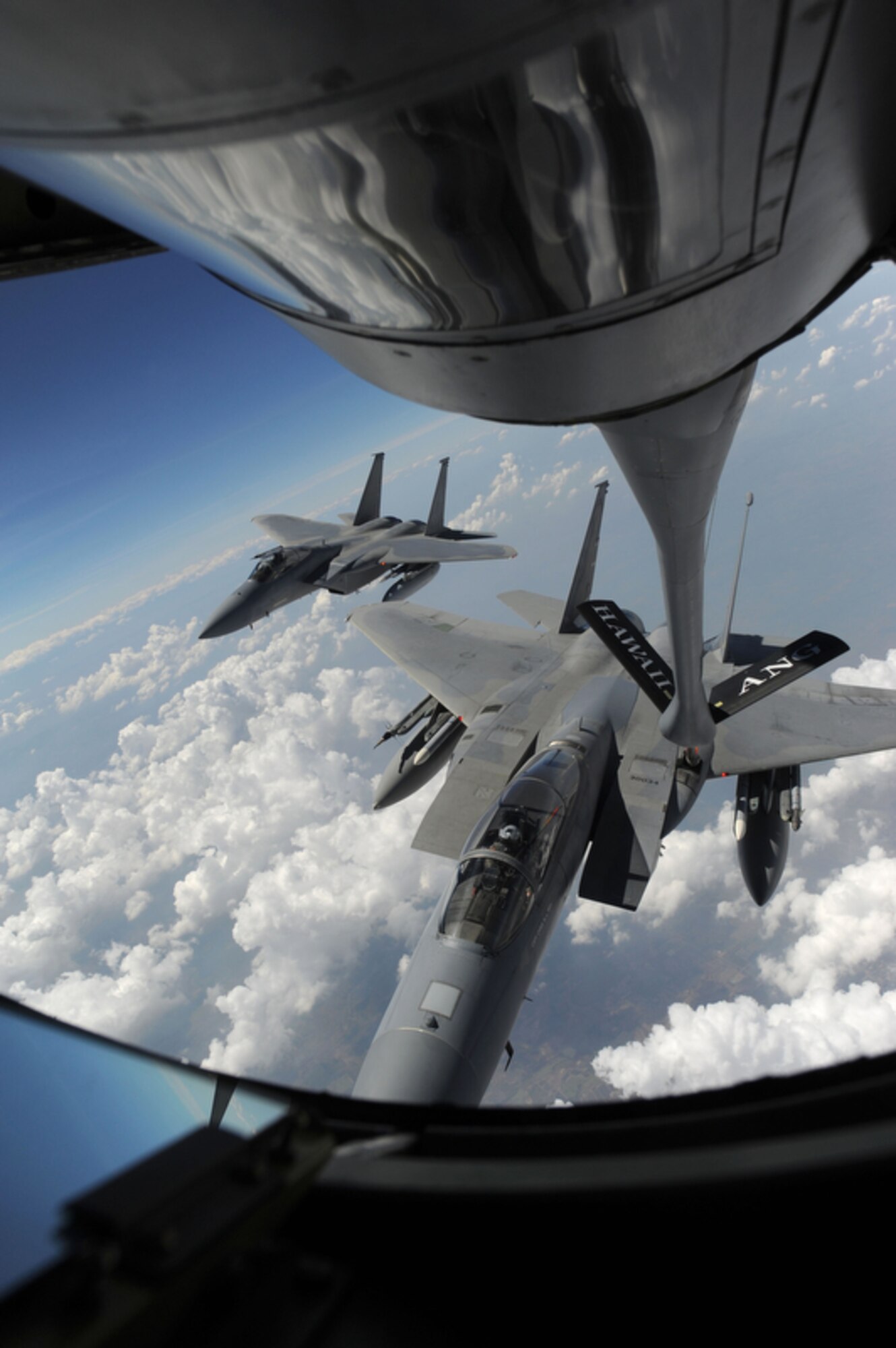 An f-15 assigned to the 44th Expeditionary Squadron, Kadena AB, Japan stays by his wingman while being refueled by a KC-135 from the 203rd Air Refueling Squadron, Joint Base Pearl Harbor-Hickam, Hawaii on March 21 over Thailand during Cope Tiger 2011,  an annual, multilateral, joint field training exercise currently being conducted at Korat and Udon Thani Royal Thai Air Bases March 14 through 25. Participants of Cope Tiger include the U.S. Air Force, the U.S. Marine Corps, the Royal Thai Air Force, Royal Thai Army, and the Republic of Singapore Air Force. (U.S.  Air Force photo/Master Sgt. Cohen A. Young)