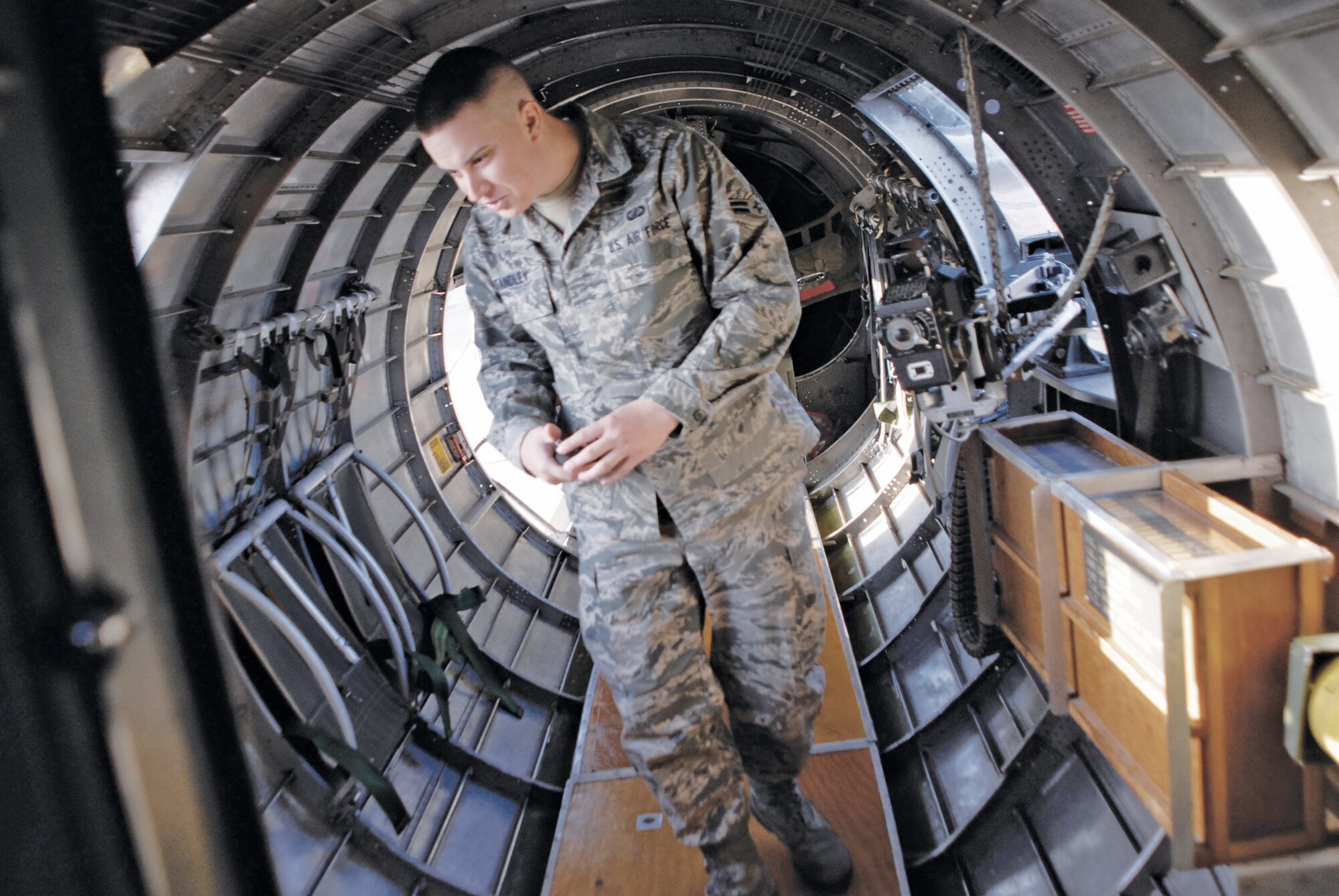 Airman 1st Class John Standley, 56th Comptroller Squadron, looks around inside B-17 before the flight March 18 from Falcon Field to Luke Air Force Base. Each of the eight members chosen for the flight had a family member with a connection to the B-17.  (U.S. Air Force photo/Airman 1st Class David Owsianka)