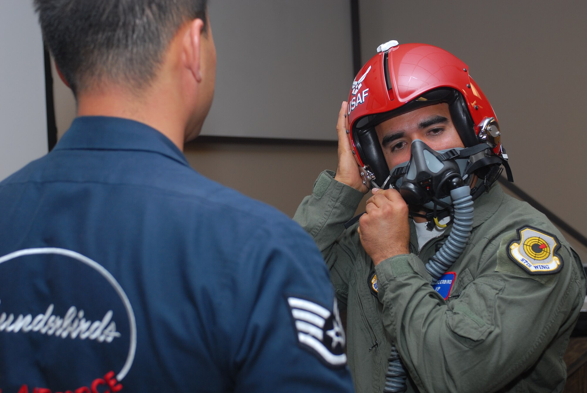 The Thunderbirds Aerial Demonstration Team Hometown Hero, Oscar Navarro, a Goodyear Fire Department firefighter, tries on a helmet and mask March 17 before his flight with the Thunderbirds in an F-16 Fighting Falcon.  (U.S. Air Force photo/Senior Airman Tracie Forte)