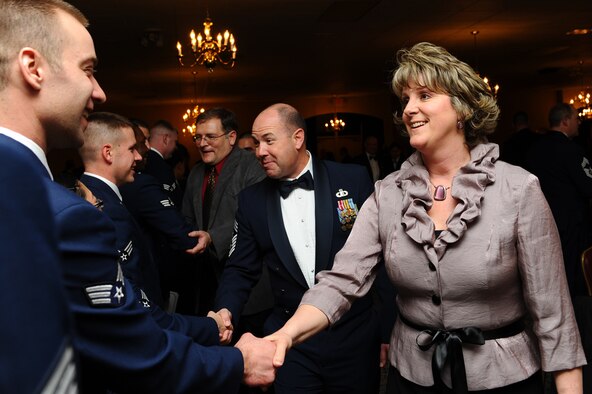 Jennifer Lavoie, wife of Chief Master Sgt. Brian Lavoie, 28th Bomb Wing command chief, congratulates Airmen for completing Airman Leadership School at Ellsworth Air Force Base, S.D., March 24, 2011.  Twenty-eight Airmen graduated from ALS. (U.S. Air Force photo/Senior Airman Kasey Close)
