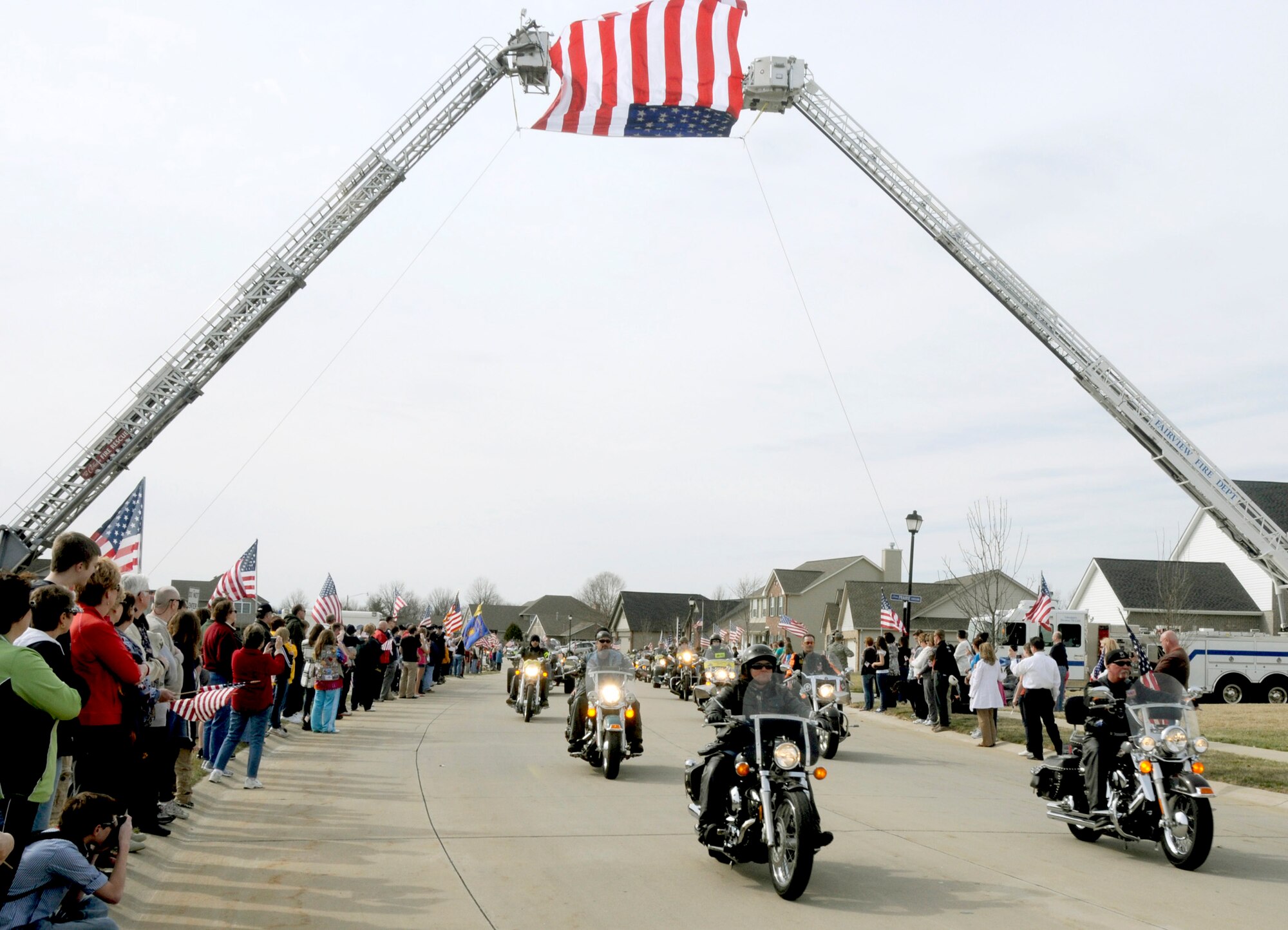 Patriot Guard Riders lead the funeral procession route of Airman 1st Class Zachary Cuddeback March 12, 2011, in O'Fallon, Ill. Airman Cuddeback and another Airman were killed March 2 when a man opened fire on a bus carrying U.S. Airmen at an airport in Frankfurt, Germany. Airman Cuddeback will be laid to rest next to his grandfather at a cemetery in O'Fallon, Ill. (U.S. Air Force photo/Staff Sgt. Brian J. Valencia)