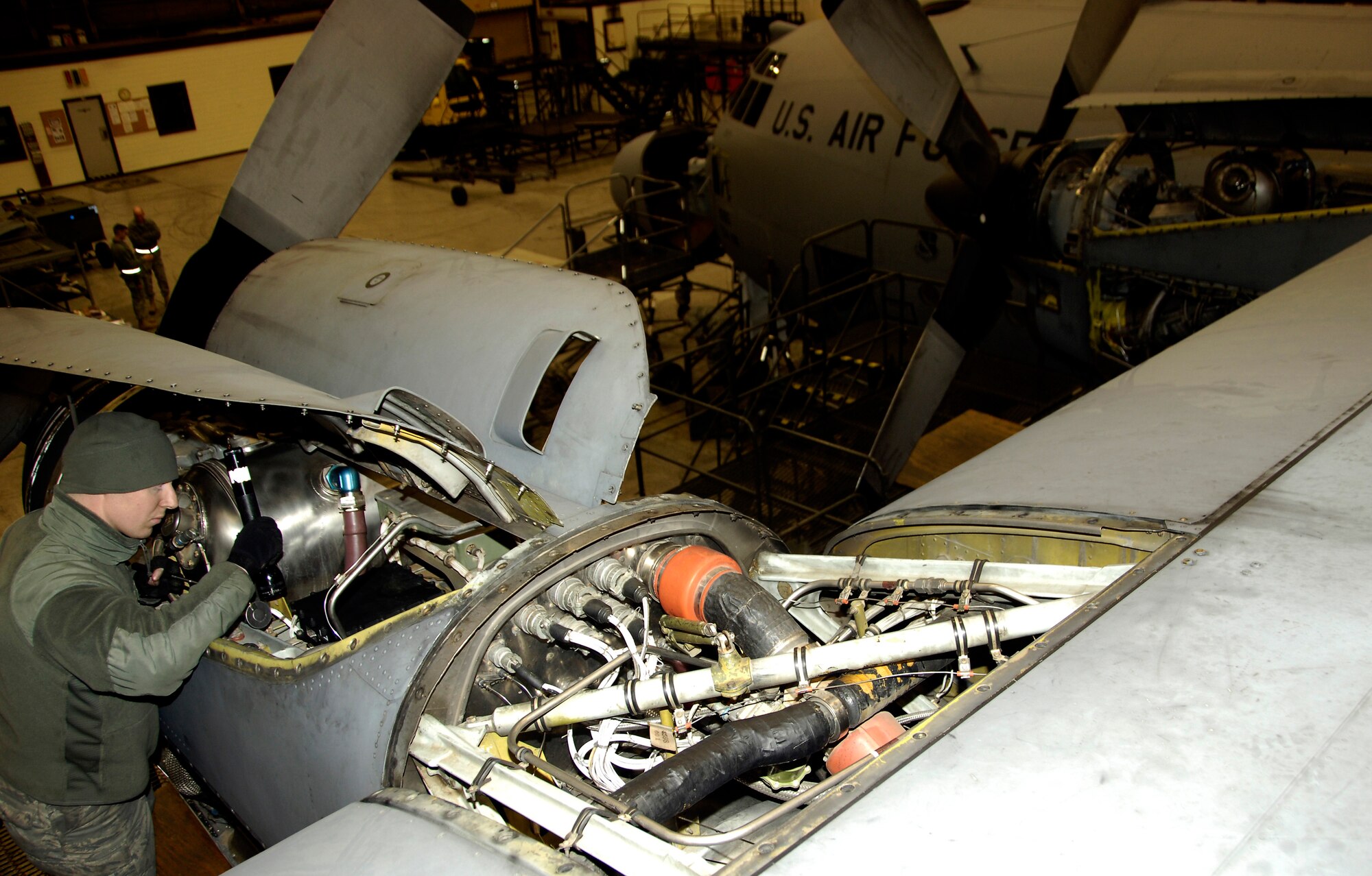 YOKOTA AIR BASE, Japan -- Staff Sgt. Justin Walsh inspects the oil tank in a C-130 Hercules engine March 25, 2011. The C-130 is undergoing routine maintenace in preparation to support Operation Tomodachi. Sergeant Walsh, a nine-year Air Force veteran, is an aerospace propulsion journeyman with the 374th Maintenance Squadron. (U.S. Air Force photo/ Staff Sgt. J.G. Buzanowski)