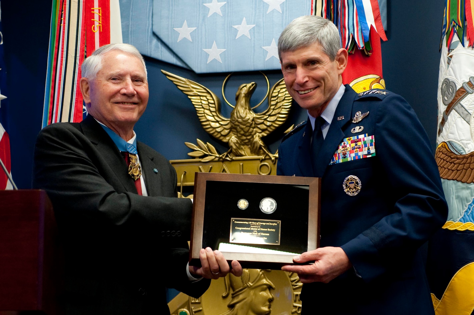 Retired Col. Leo K. Thorsness, president of the Congressional Medal of Honor Society, presents Air Force Chief of Staff Gen. Norton Schwartz with a memorial plaque March 25, 2011, during a ceremony honoring the 150th anniversary of the Medal of Honor in the Hall of Heroes at the Pentagon in Washington, D.C. (Department of Defense photo/Petty Officer 1st Class Chad J. McNeeley)