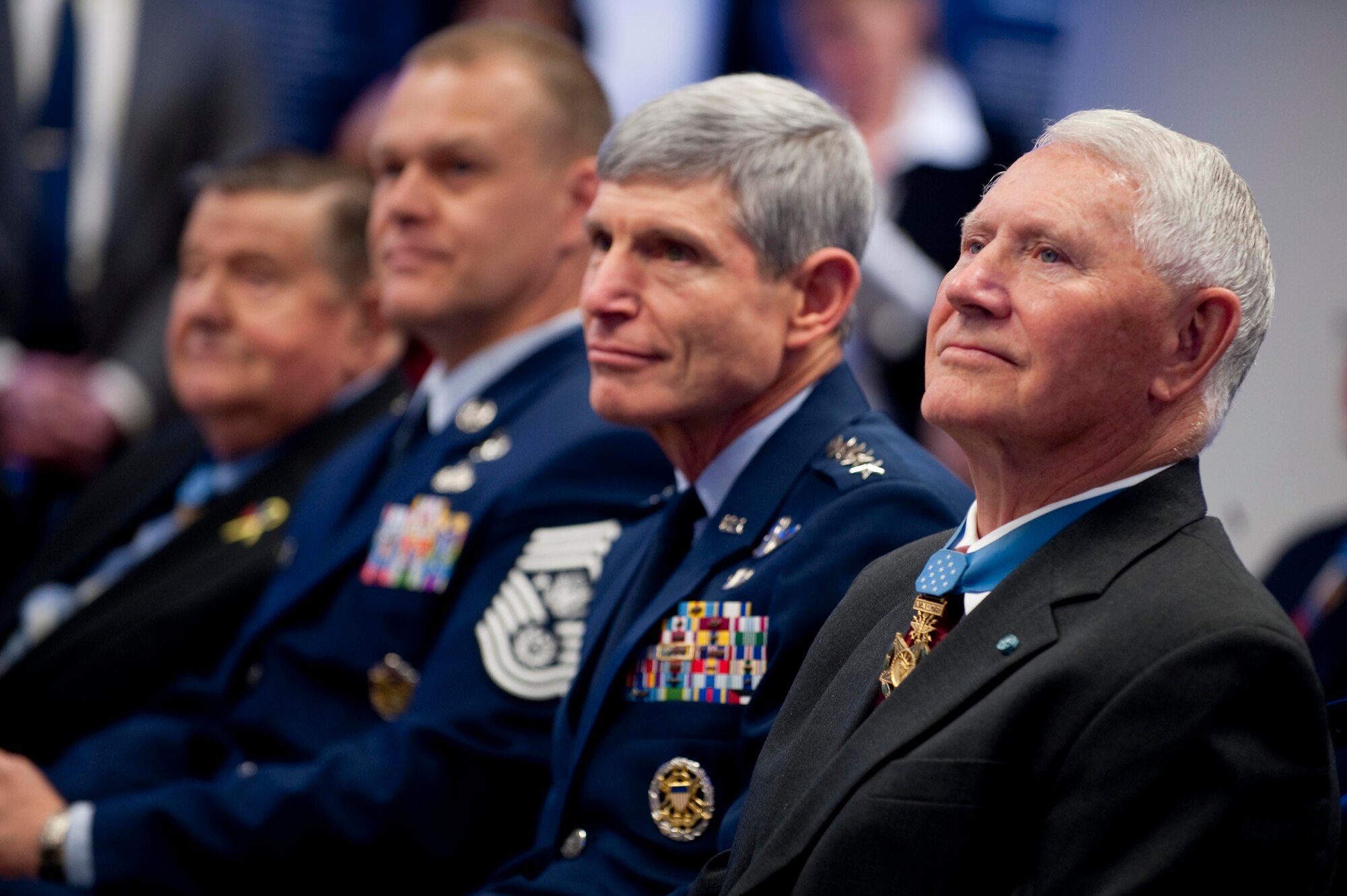 Retired Col. Leo K. Thorsness, president of the Congressional Medal of Honor Society; Air Force Chief of Staff Gen. Norton Schwartz; and Chief Master Sgt. of the Air Force James A. Roy listen to a speaker March 25, 2011, during a ceremony honoring the 150th anniversary of the Medal of Honor in the Hall of Heroes at the Pentagon in Washington, D.C. (Department of Defense photo/Petty Officer 1st Class Chad J. McNeeley)