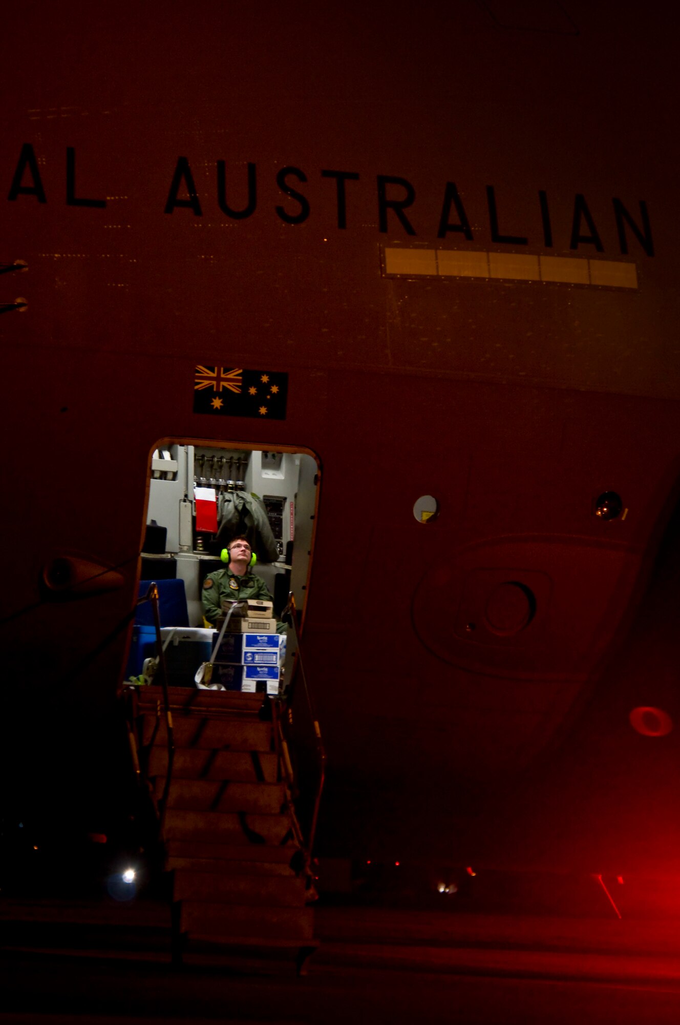 YOKOTA AIR BASE, Japan -- A Royal Australian Air Force loadmaster sits in a C-17 Globemaster III prior to taking off for Australia here March 25. RAAF Aircrews flew multiple humanitarian airlift missions from Yokota Air Base in support of Operation Tomodachi. (U.S. Air Force photo/Staff Sgt. Chad C. Strohmeyer)
