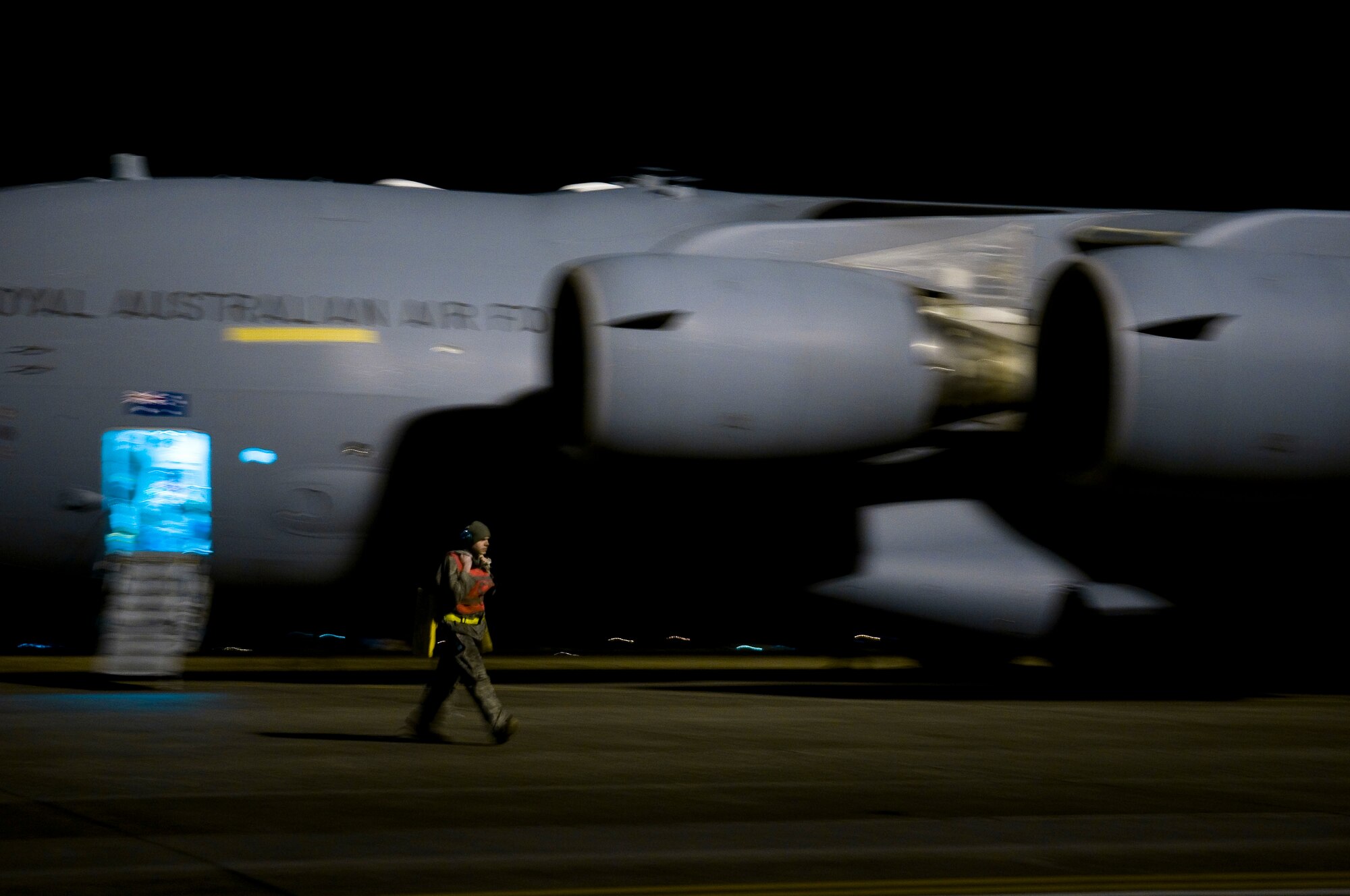YOKOTA AIR BASE, Japan -- Staff Sgt. Jakob Gadelman 730th Air Mobility Squadron crew chief, walks over to his gear prior to launching the Royal Australian Air Force C-17 Globemaster III here March 25. The RAAF provided vital airlift for humanitarian supplies in support of Japanese disaster relief efforts. (U.S. Air Force photo/Staff Sgt. Chad C. Strohmeyer)