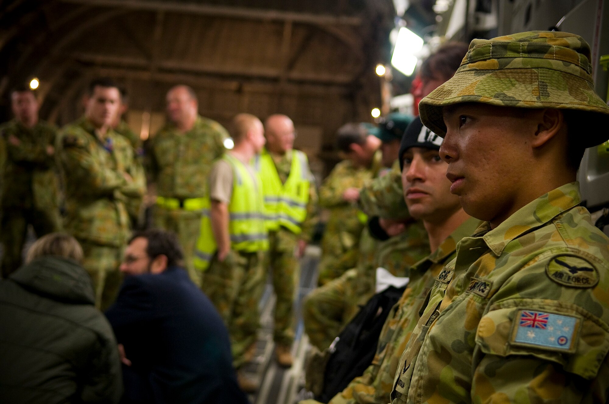 YOKOTA AIR BASE, Japan -- Royal Australian Air Force members sit and wait for their departure back to Australia on a Royal Australian Air Force C-17 Globemaster III here March. 25. The RAAF joined several nations, including the U.S. in supporting Japanese disaster relief efforts. (U.S. Air Force photo/Staff Sgt. Chad C. Strohmeyer)
