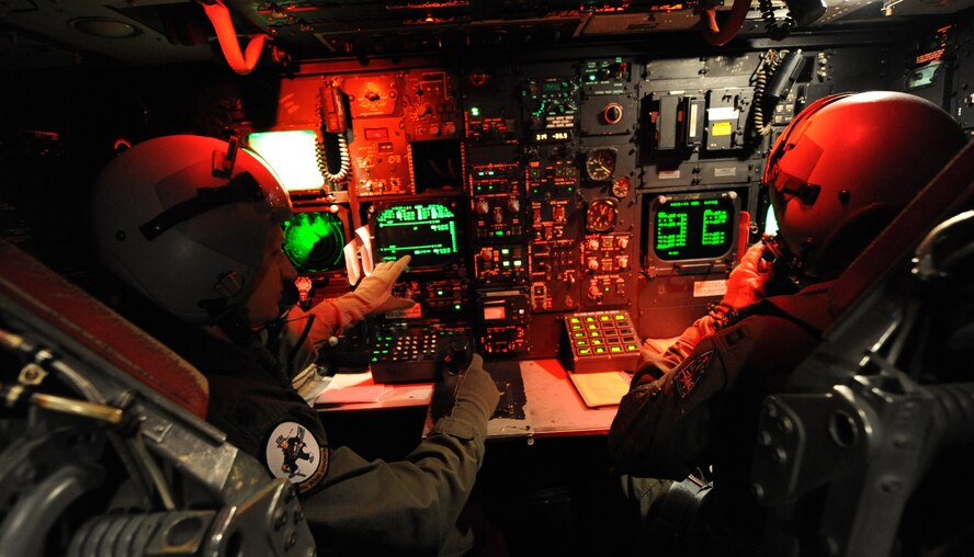 Lt. Col. Kieran Denehan, 11th Bomb Squadron commander, sits in the radar navigator's seat and reviews information with Capt. Robert Campbell, 11 BS navigator, during a sortie in a B-52H Stratofortress from Barksdale Air Force Base, La., March 25. (U.S. Air Force photo/Senior Airman Alexandra M. Boutte) (RELEASED)