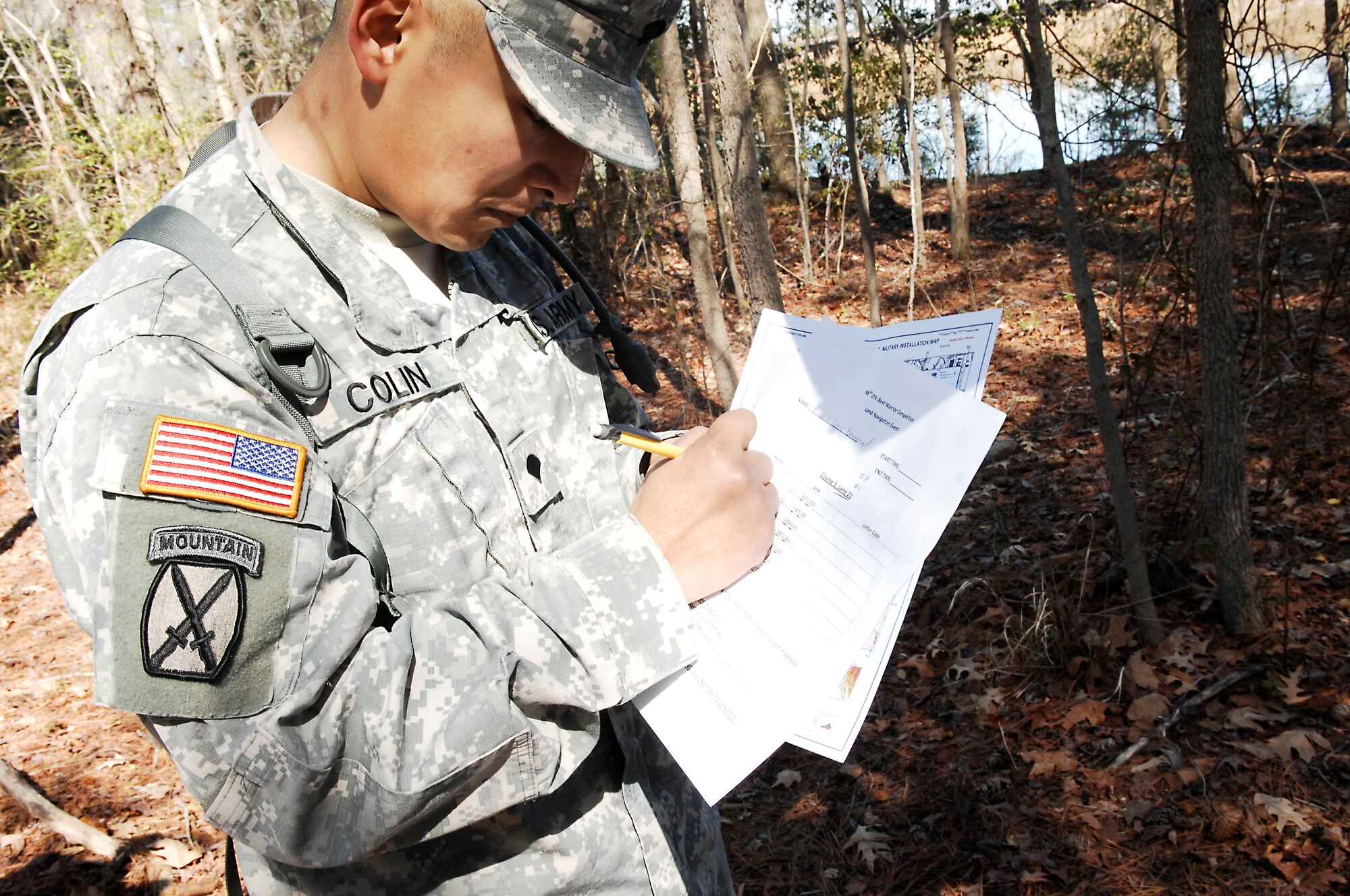 Army Spc. Ricardo Colin, drill sergeant candidate, Alpha Company, 3rd Battalion, 318th Regiment, plots coordinates during the land navigation portion of the Best Warrior competition at Fort Eustis, Va., March 25, 2011. Soldiers from various bases displayed their mental and physical capabilities to win Best Warrior in their division. (U.S. Air Force photo by Airman 1st Class Kayla Newman/Released)
