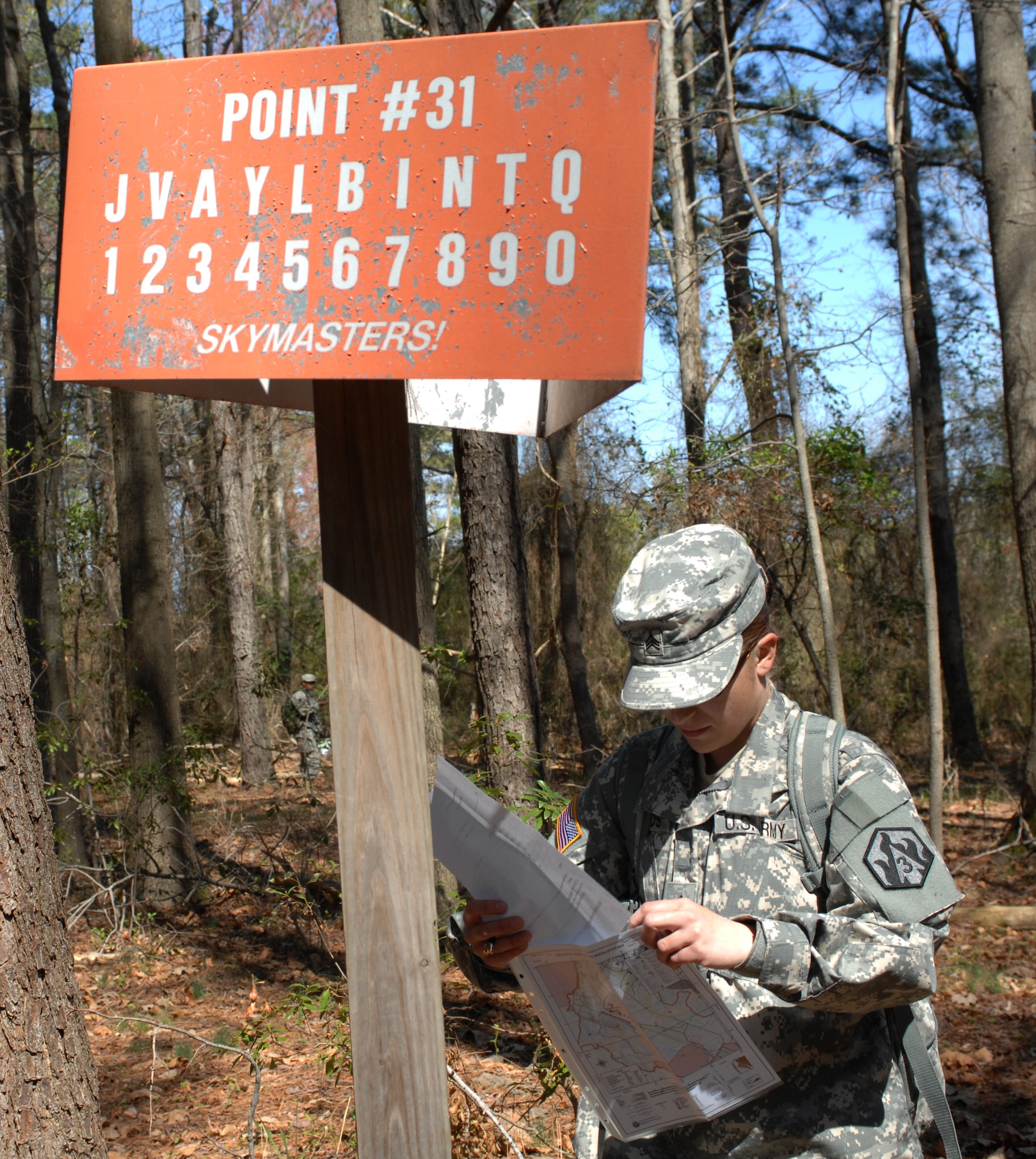 Army Sgt Sarah Woods, drill sergeant candidate with Charlie Company, 2nd Battalion, 417th Regiment, views marked coordinate points during the land navigation portion of the Best Warrior competition at Fort Eustis, VA., March 25, 2011. Soldiers must navigate through combat environments to test their abilities and compete for the title of Best Warrior in their division. (U.S. Air Force photo by Airman 1st Class Teresa Zimmerman/Released)