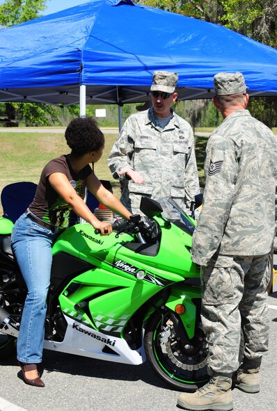 MOODY AIR FORCE BASE, Ga.--Tech. Sgt Joel Barnett, 23rd Wing Safety Office, talks to Adrienne Wilkerson, 23rd Force Support Squadron marketing director, about the different programs and motorcycle classes the safety office provides March 25. The motorcycle safety basic riding course has many different styles of bikes from cruisers to sports bikes. (U.S. Air Force photo/Senior Airman Stephanie Mancha)(RELEASED)