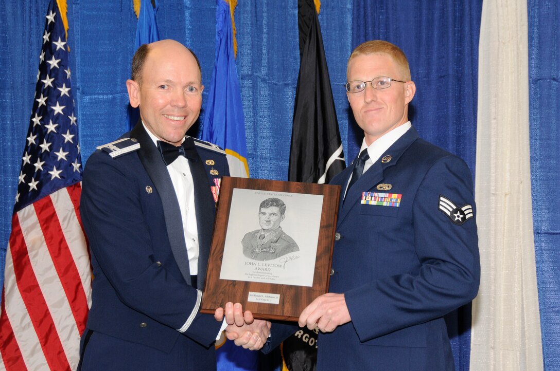 McGHEE TYSON AIR NATIONAL GUARD BASE, Tenn. - Senior Airman Ronald Allshouse, right, an aircraft structural maintenance journeyman with the Air Force Reserve at Beale AFB, Calif., receives the John L. Levitow honor award for Airman Leadership School Class 11-3 at The I.G. Brown Air National Guard Training and Education Center from Col. Bradley N. McRee, TEC commander, March 24, 2011.  The John L. Levitow award is the highest honor awarded a graduate of any Air Force enlisted professional military education course.  (U.S. Air Force photo by Master Sgt. Kurt Skoglund/Released)