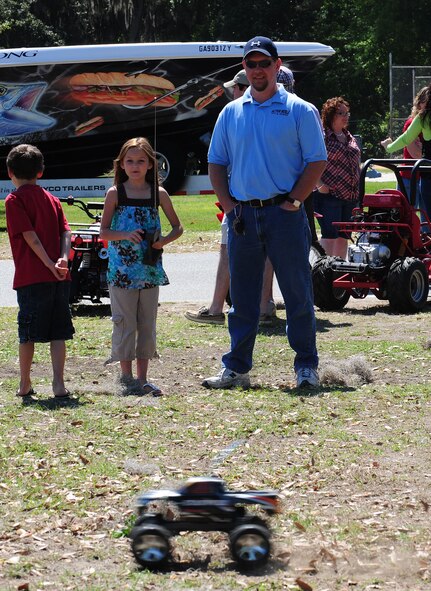 MOODY AIR FORCE BASE, Ga.--Brook and Brandon Callicoat, 8, niece and nephew of Tech. Sgt. Jason Pines, 23rd Logistics Readiness Squadron NCO in charge fuels distribution supervisor, steers a remote control car March 25. The children enjoyed steering the remote control cars during the Outdoor Extravaganza.(U.S. Air Force photo/Senior Airman Stephanie Mancha)(RELEASED)