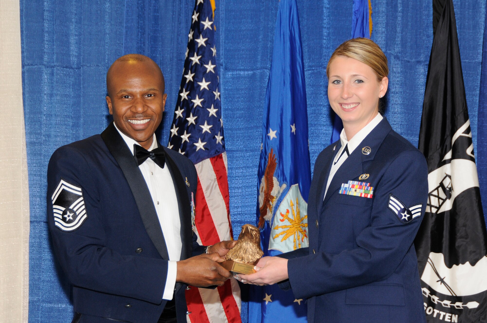 McGHEE TYSON AIR NATIONAL GUARD BASE, Tenn. - Senior Airman Casandra J. Pohlen, right, a civil engineer apprentice with the Minnesota Air National Guard, receives the academic achievement award for Airman Leadership School Class 11-3 at The I.G. Brown Air National Guard Training and Education Center from Senior Master Sgt. Tyrone Bingham, EPME Director of Education, March 24, 2011.  The academic achievement award denotes excellence as a scholar. It is based upon all summative objective tests and individual performance evaluations and is given to the student with the highest overall academic standing. (U.S. Air Force photo by Master Sgt. Kurt Skoglund/Released)
