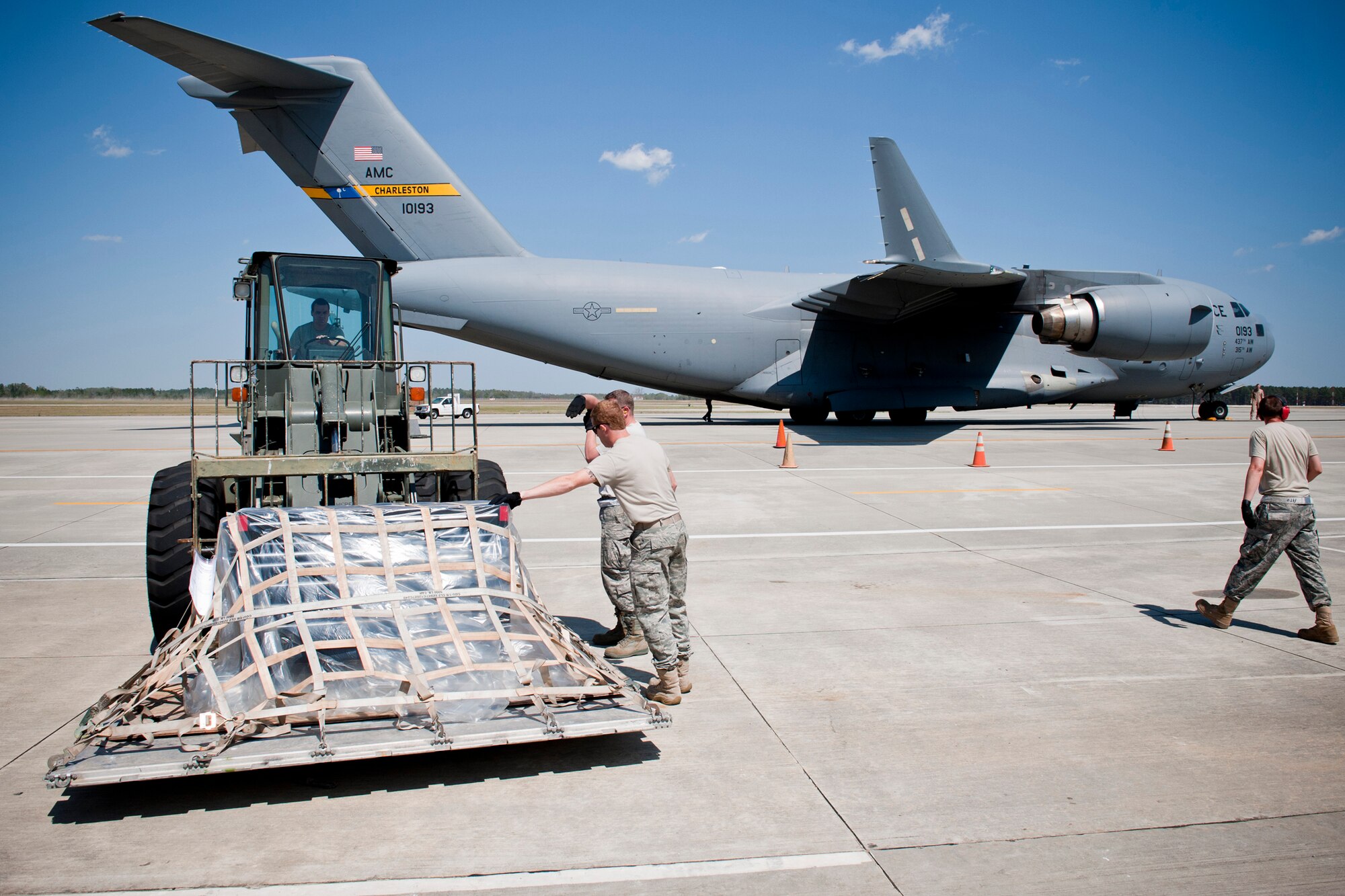 Members of the 23rd Logistics Readiness Squadron vehicle maintenance and materiel management flights prepare a pallet of cargo for shipment onto a C-17 Globemaster III March 24 at Moody Air Force Base, Ga. The cargo contained support equipment for the 74th Fighter Squadron downrange. (U.S. Air Force photo/Staff Sgt. Jamal D. Sutter)(RELEASED)