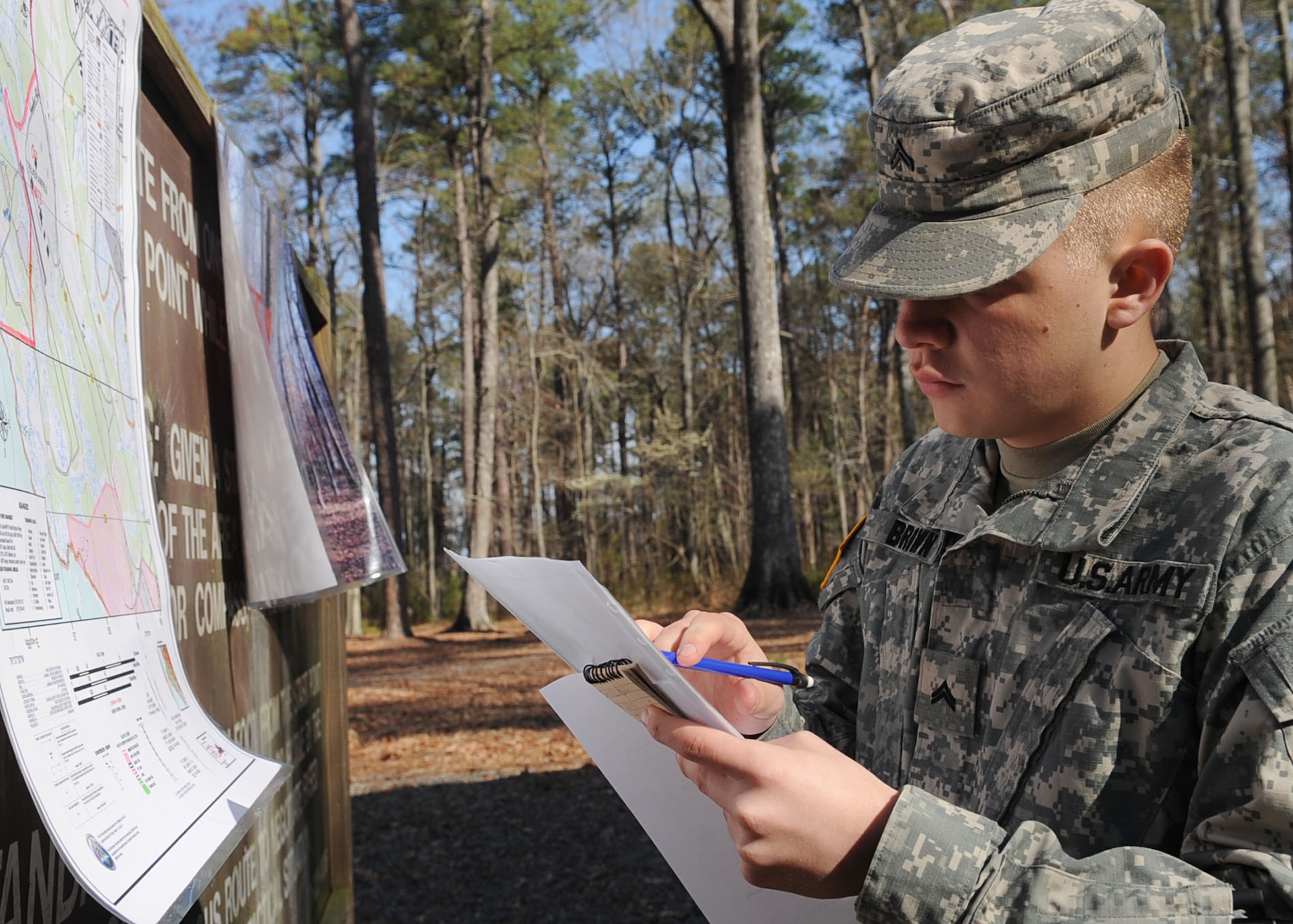 Army Cpl. Andrew Brown, drill Sgt candidate with Alpha Company, 2nd Battalion, 389th Regiment, uses the map key for coordinate placement during the land navigation portion of the Best Warrior competition at Fort Eustis, Va., March 25, 2011. Soldiers from various bases tested their physical and mental capabilities in combat environments to earn the title of Best Warrior in their division. (U.S. Air Force photo by Staff Sgt. Ashley Hawkins/Released)
