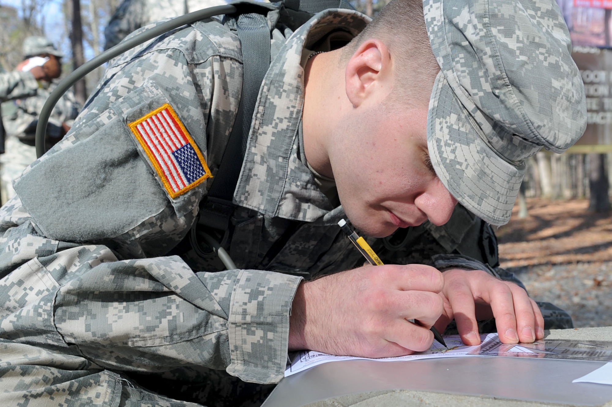 Army Sgt. Kenneth Gaudreau, drill sergeant candidate with 2nd Battalion, 317th Regiment, plots coordinates before the land navigation portion of the Best Warrior competition at Fort Eustis, Va., March 25, 2011. Soldiers from various bases tested their physical and mental capabilities in combat environments to earn the of title Best Warrior in their division. (U.S. Air Force photo by Staff Sgt. Ashley Hawkins/Released)