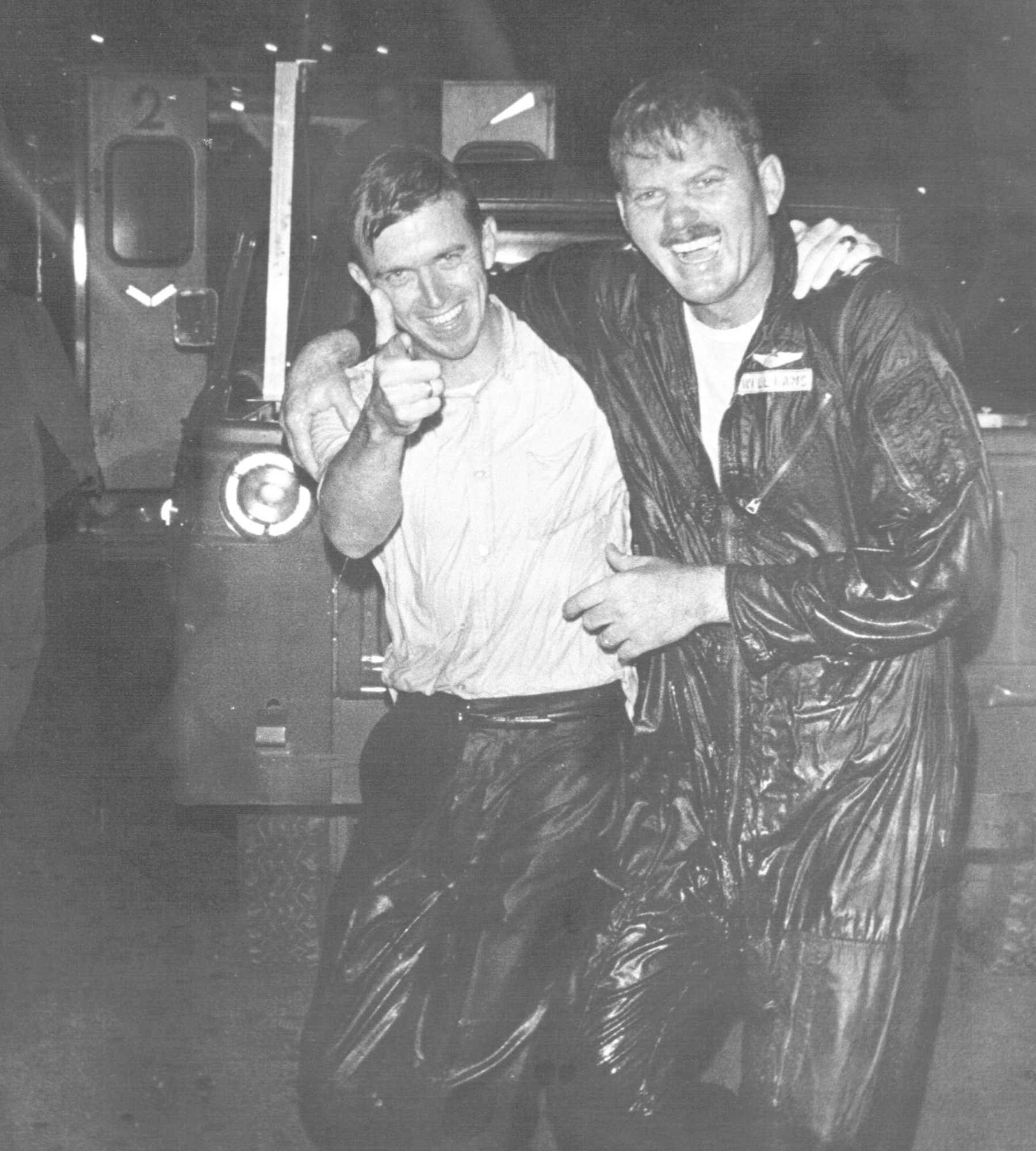 Wet from the traditional last-mission hose down, Maj. Dick Williams (left) and Maj. Thomas Stack celebrate completing their tour. (U.S. Air Force photo)