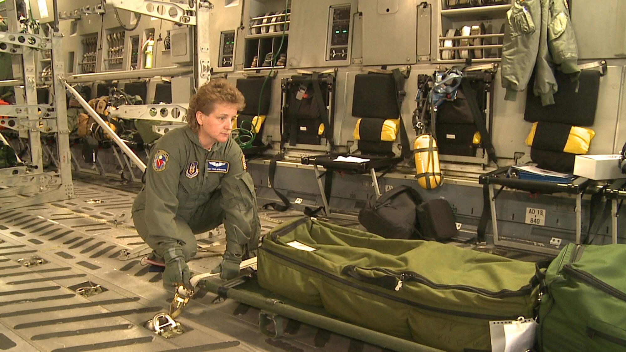 WRIGHT-PATTERSON AIR FORCE BASE, Ohio - Master Sgt. Tina McNamara, 445th Aeromedical Evacuation Squadron, straps in a patient litter onboard a C-17 Globemaster III in preparation for take-off as part of her unit’s flying training mission March 18. (U.S. Air Force photo/Ken LaRock)