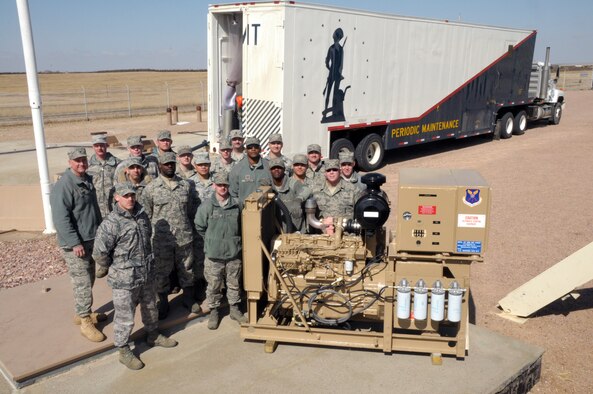 Col. Greg Tims, 90th Missile Wing commander, poses with members of the 90th Maintenance Group next to the last Cummins diesel engine to replace the nearly 50-year-old back-up power supply in the missile field. (U.S. Air Force photo by Blaze Lipowski)