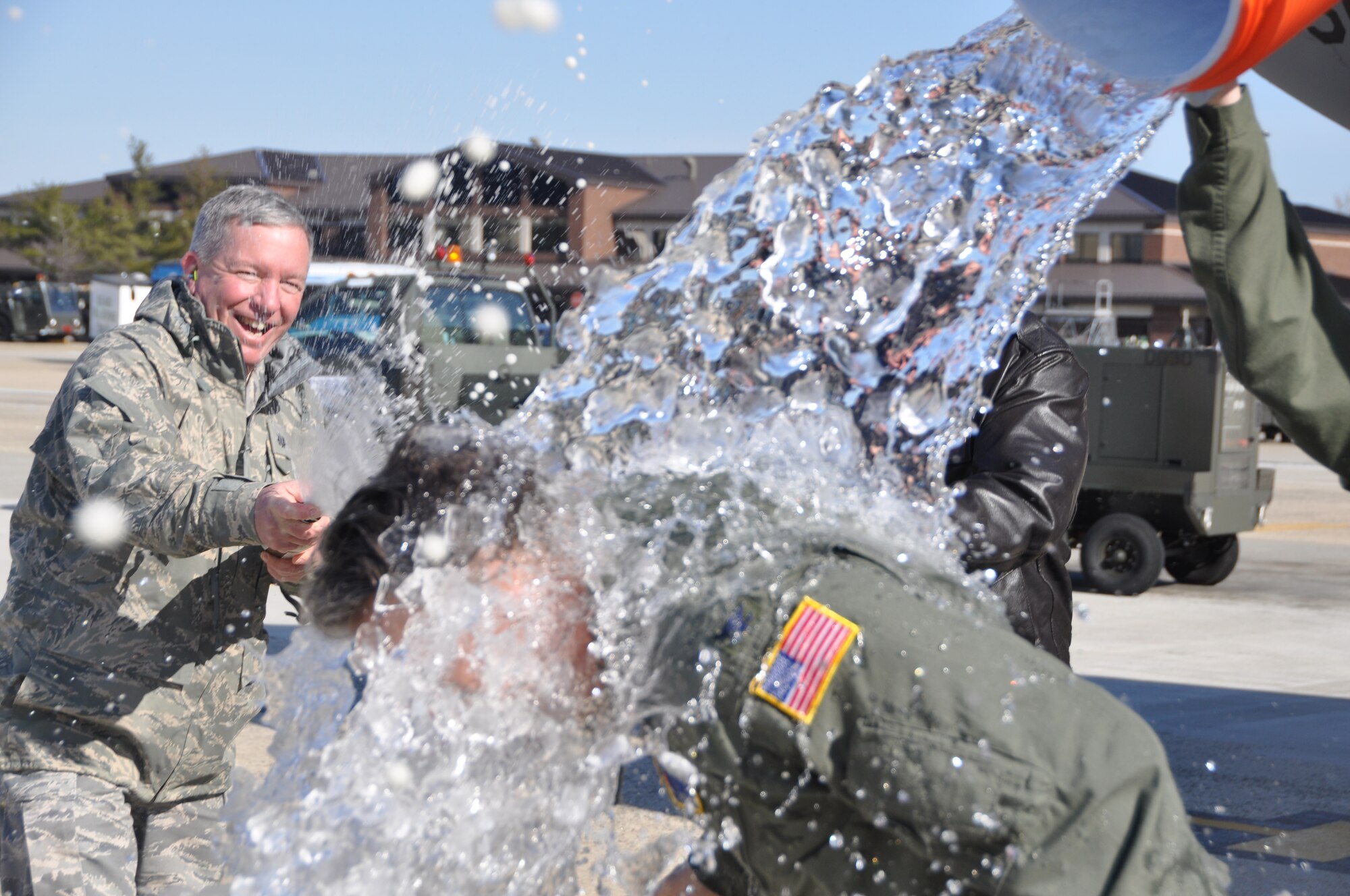 JOINT BASE MCGUIRE-DIX-LAKEHURST, N,J - Col. Giordano McMullen, 514th Air Mobility Wing commander is met with a shower of water as he exits a C-17 Globemaster III,  March 25, after landing from his final flight. Colonel McMullen retires from the Air Force Reserve on March 27 after 30 years of service. (U.S. Air Force photo/Master Sgt. Donna T. Jeffries)