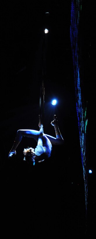 A performer from the Ringling Brothers and Barnum & Bailey Circus dangles high above the crowd March 24 at the Verizon Center in Washington, D.C.  The March 24 show was a salute to military heroes, with many wounded warriors from Walter Reed Army Medical Center and their families in attendance. (U.S. Air Force photo by Senior Airman Torey Griffith)