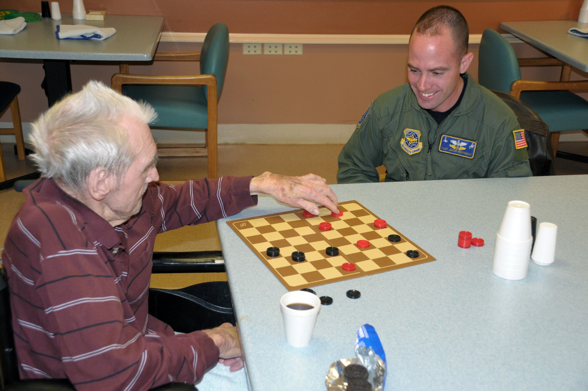 Tech. Sgt. Jason Meermans, 30th Airlift Squadron, plays a game of checkers with Chet Dods, a World War II veteran, at the Cheyenne Veteran’s Affairs medical center during the Warren Top 3 visit with military veterans March 10. (U.S. Air Force photo by Blaze Lipowski)