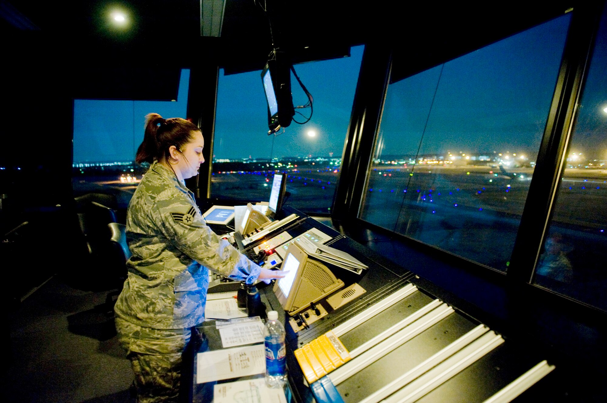 Senior Airman Lyndsi Tullos communicates with the maintenance operation center about flightline operations March 24, 2011, at Yokota Air Base, Japan. Yokota AB's flightline has received more than triple the normal amount of aircraft due to Operation Tomodachi. The military and civilian aircraft have been from multiple nations carrying supplies, personnel and equipment in direct support of bringing relief efforts and trying to minimize human suffering following an earthquake and tsunami March 11. Airman Tullos is a 374th Operations Support Squadron air traffic controller. (U.S. Air Force photo/Staff Sgt. Jonathan Steffen)