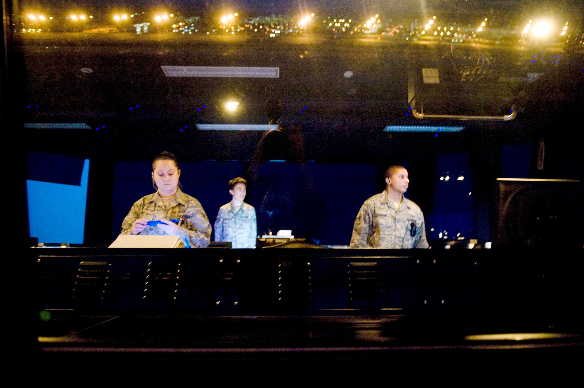 Senior Airman Lyndsi Tullos, Staff Sgt. Steven Valentine and Senior Airman Nissean Johnson maintain control of inbound and outbound aircraft March 24, 2011, at Yokota Air Base, Japan. Yokota AB's flightline has received more than triple the normal amount of aircraft due to Operation Tomodachi. The military and civilian aircraft have been from multiple nations carrying supplies, personnel and equipment in direct support of bringing relief efforts and trying to minimize human suffering following an earthquake and tsunami March 11. Sergeant Valentine and Airmen Tullos and Johnson are 374th Operations Support Squadron air traffic controllers. (U.S. Air Force photo/Staff Sgt. Jonathan Steffen)